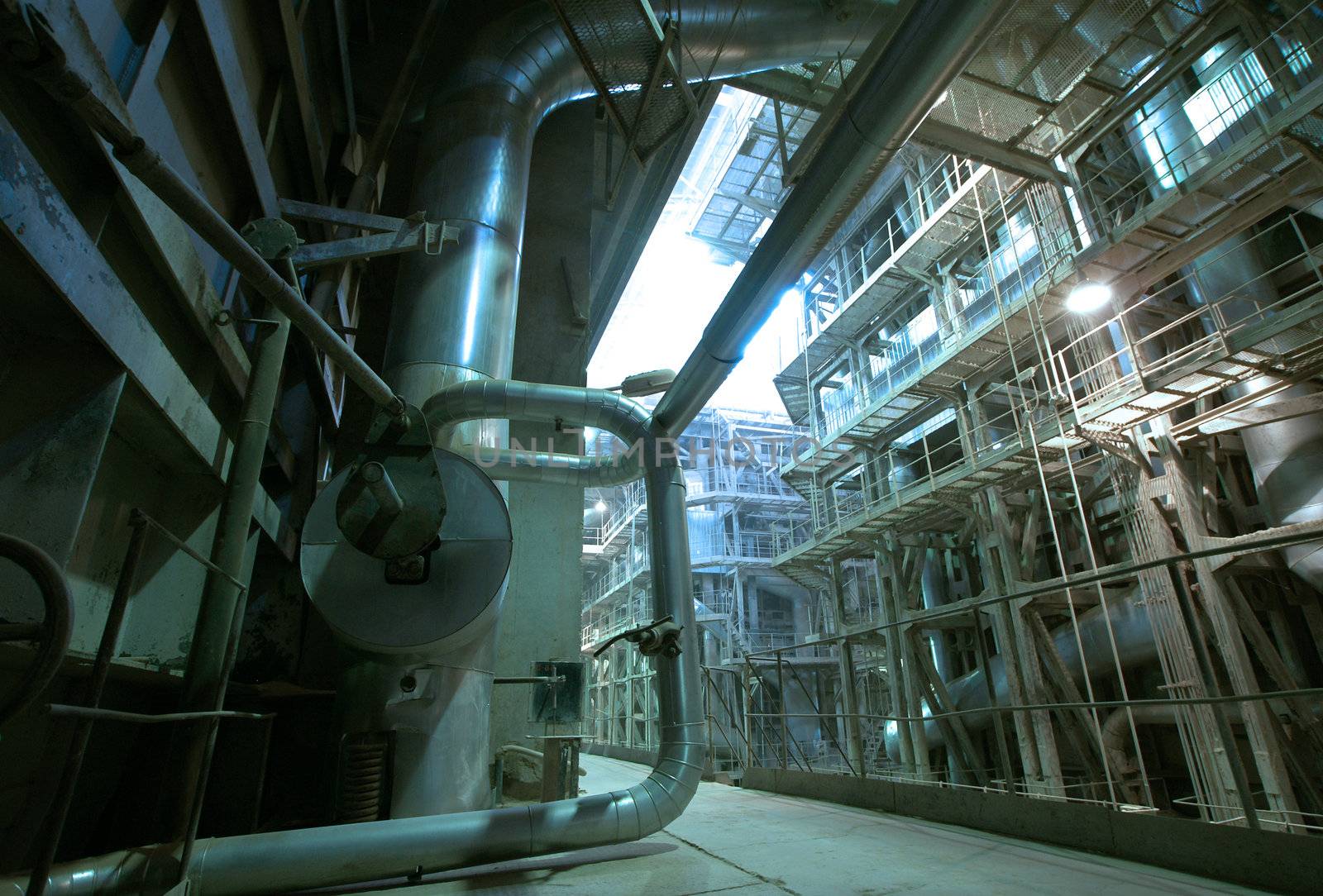 Equipment, cables and piping as found inside of  industrial power plant