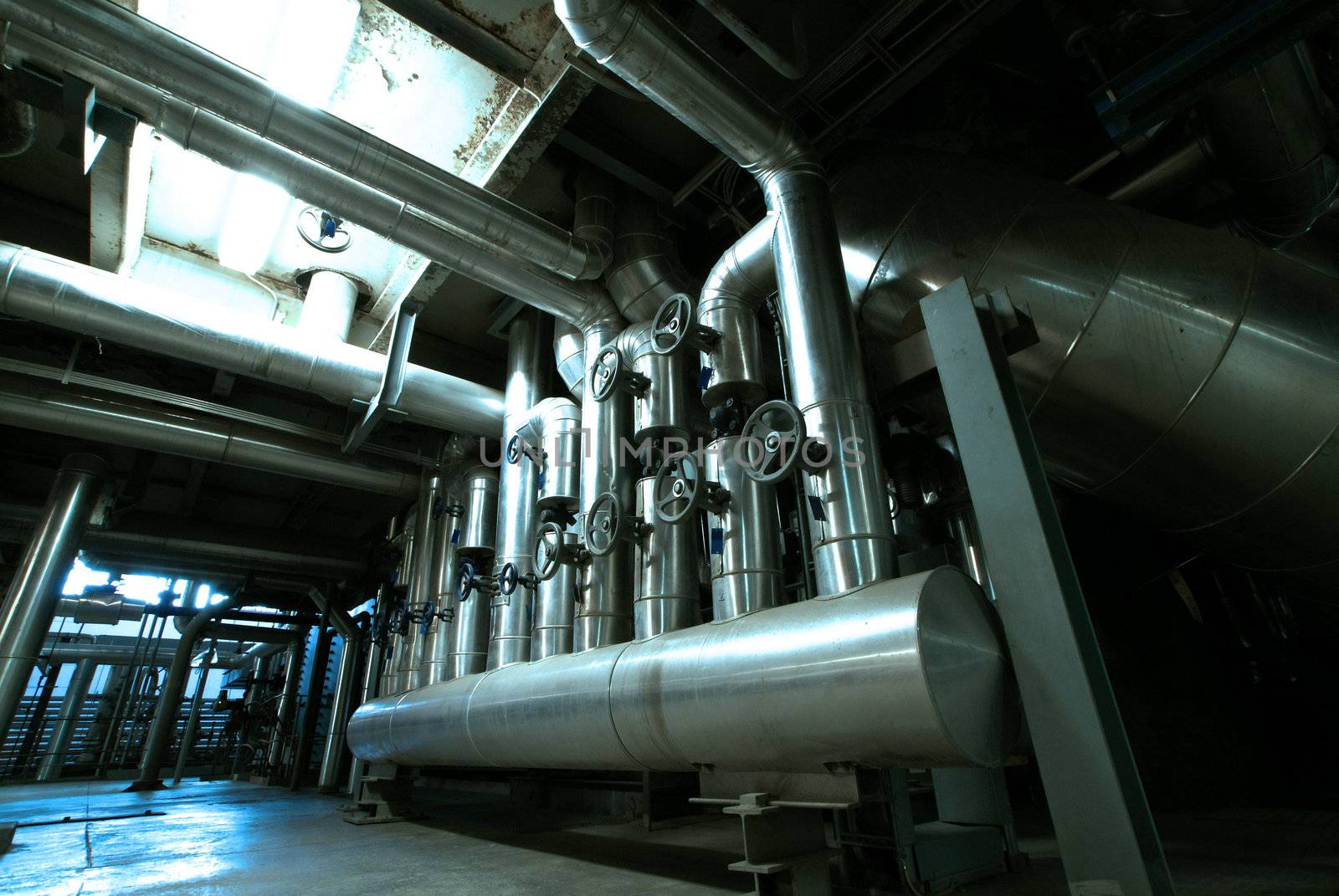 Equipment, cables and piping as found inside of  industrial power plant