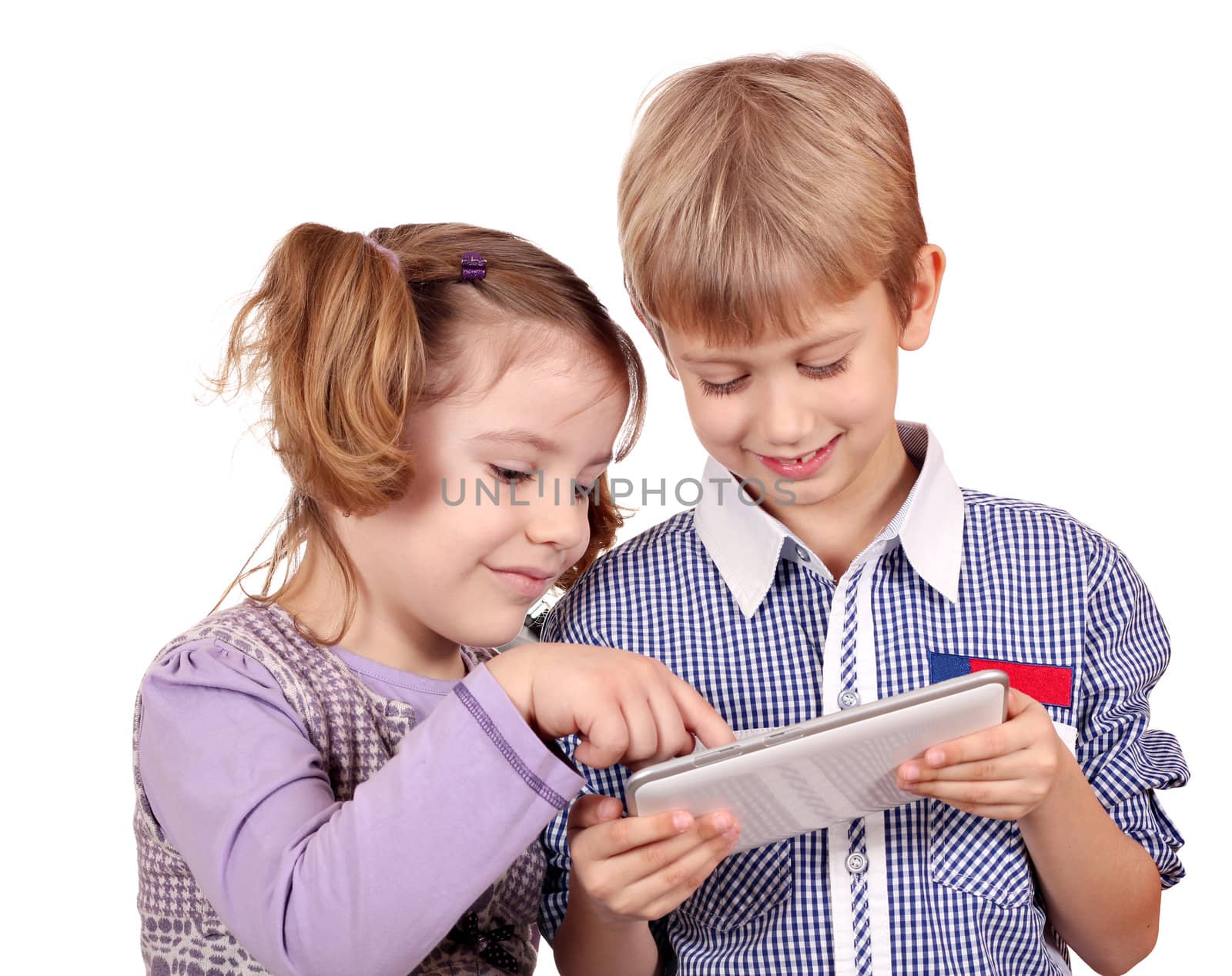 little girl and boy fun with tablet pc on white 