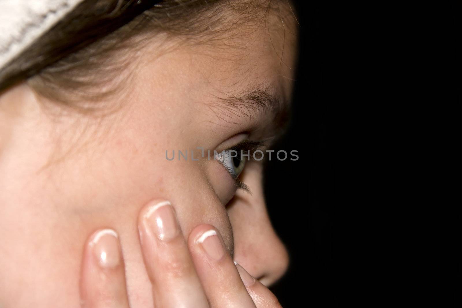 Portrait of a young teenage blue eyed girl looking somber with copyspace