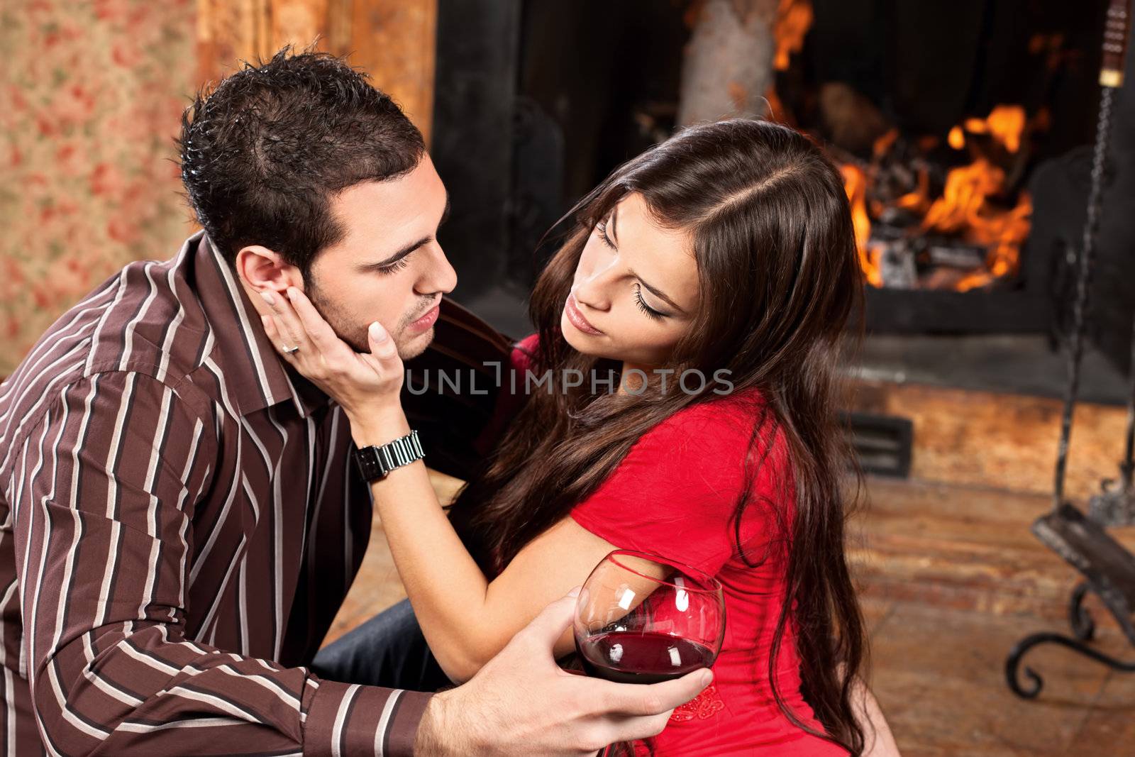 woman caress her man near fireplace by imarin