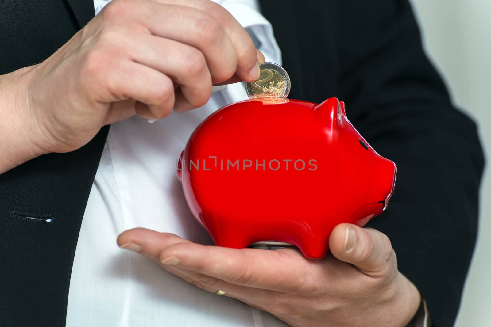 Close up pregnant business womans hands with piggy bank by w20er