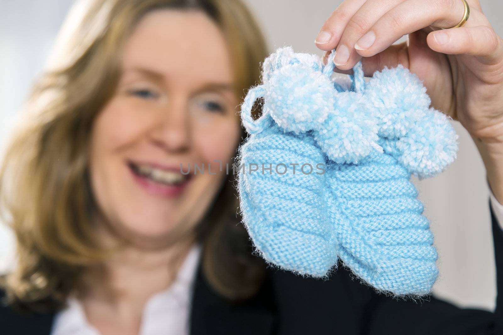 Blond woman with blue baby shoes by w20er