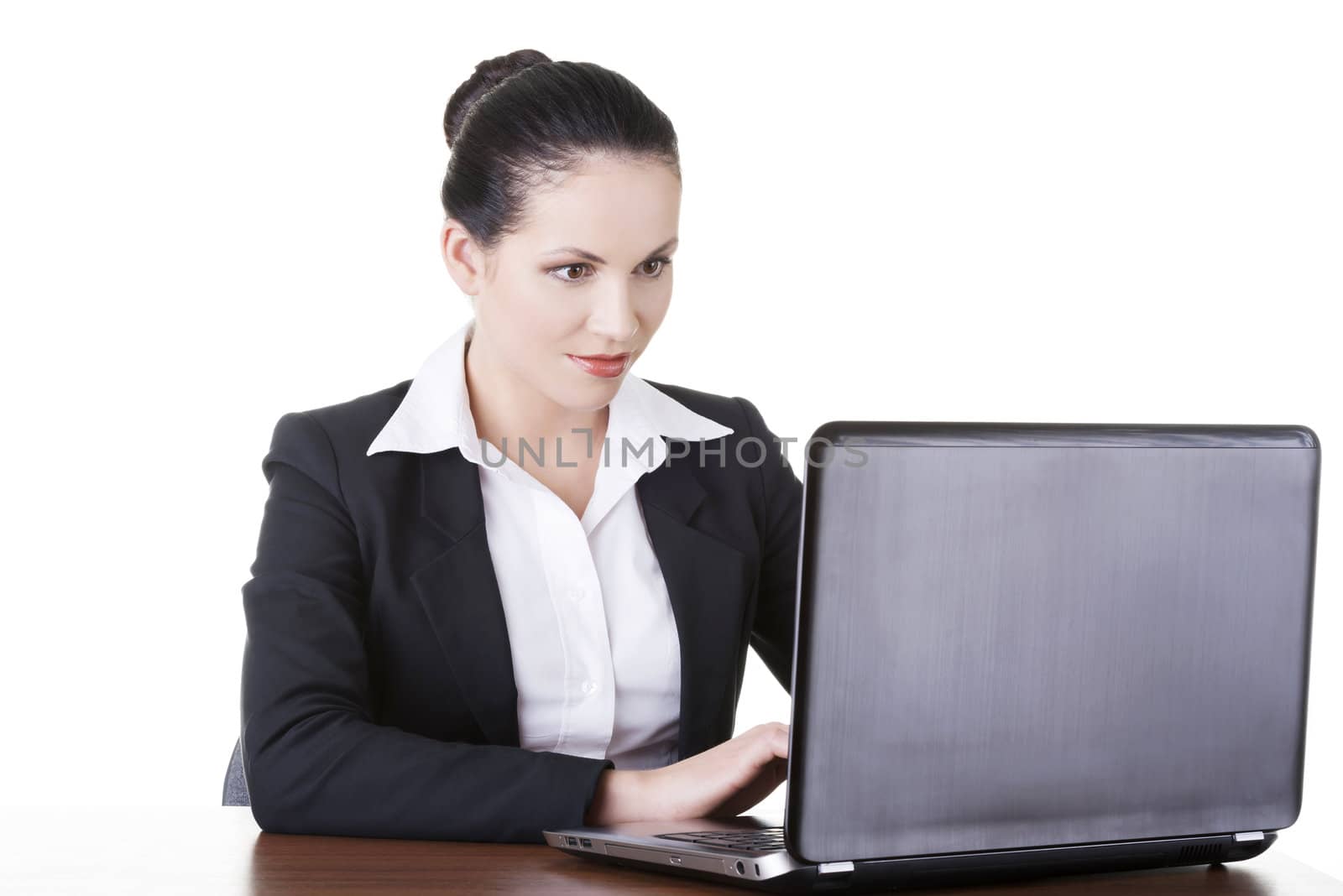Beautiful brunette businesswoman working on laptop computer isolated on white