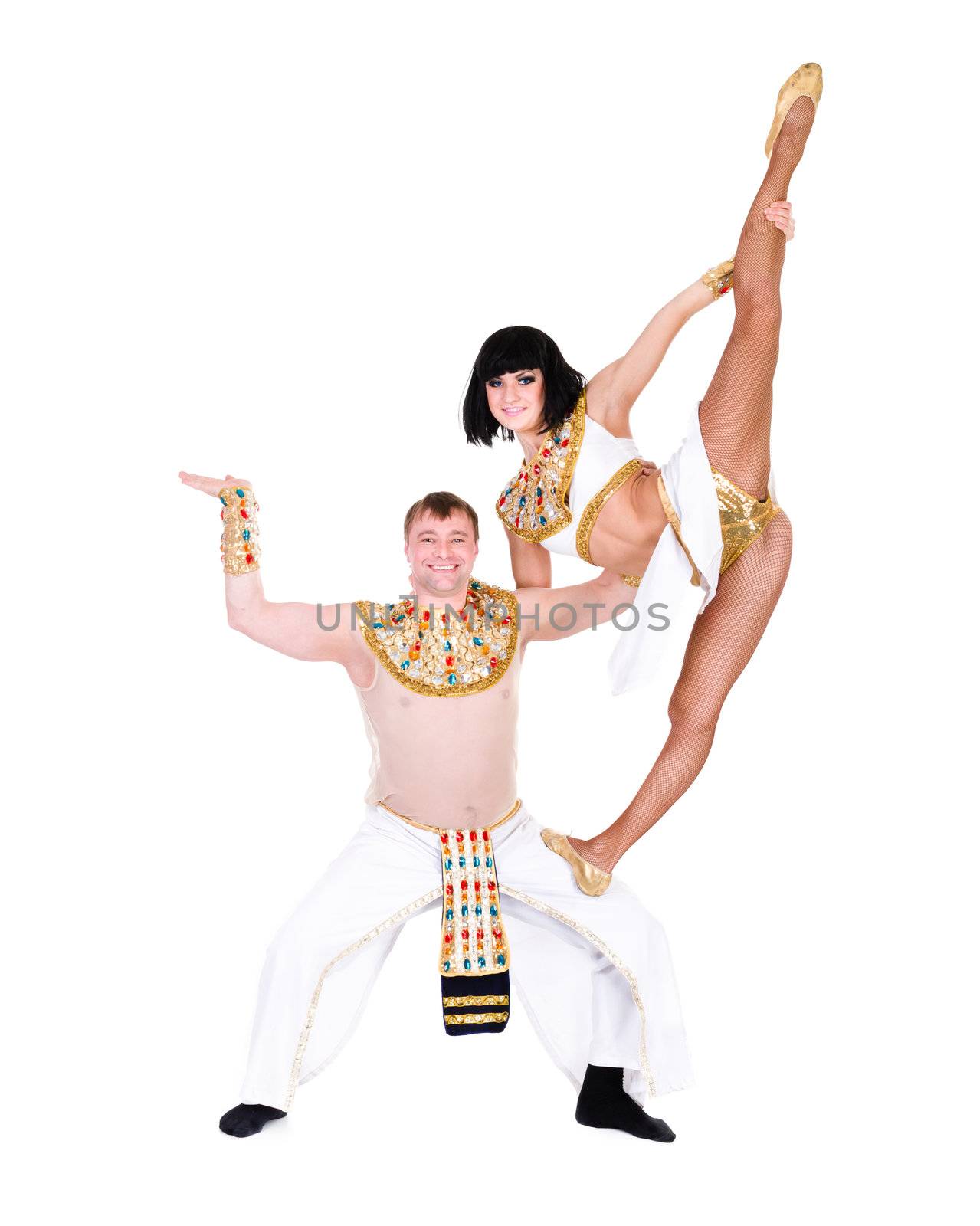 acrobatic dance couple wearing a egyptian costume doing splits against isolated white background