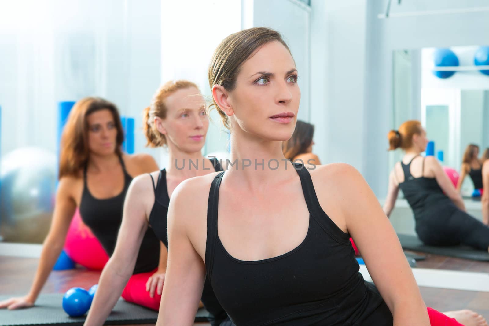 Beautiful women group in a row at aerobics class by lunamarina