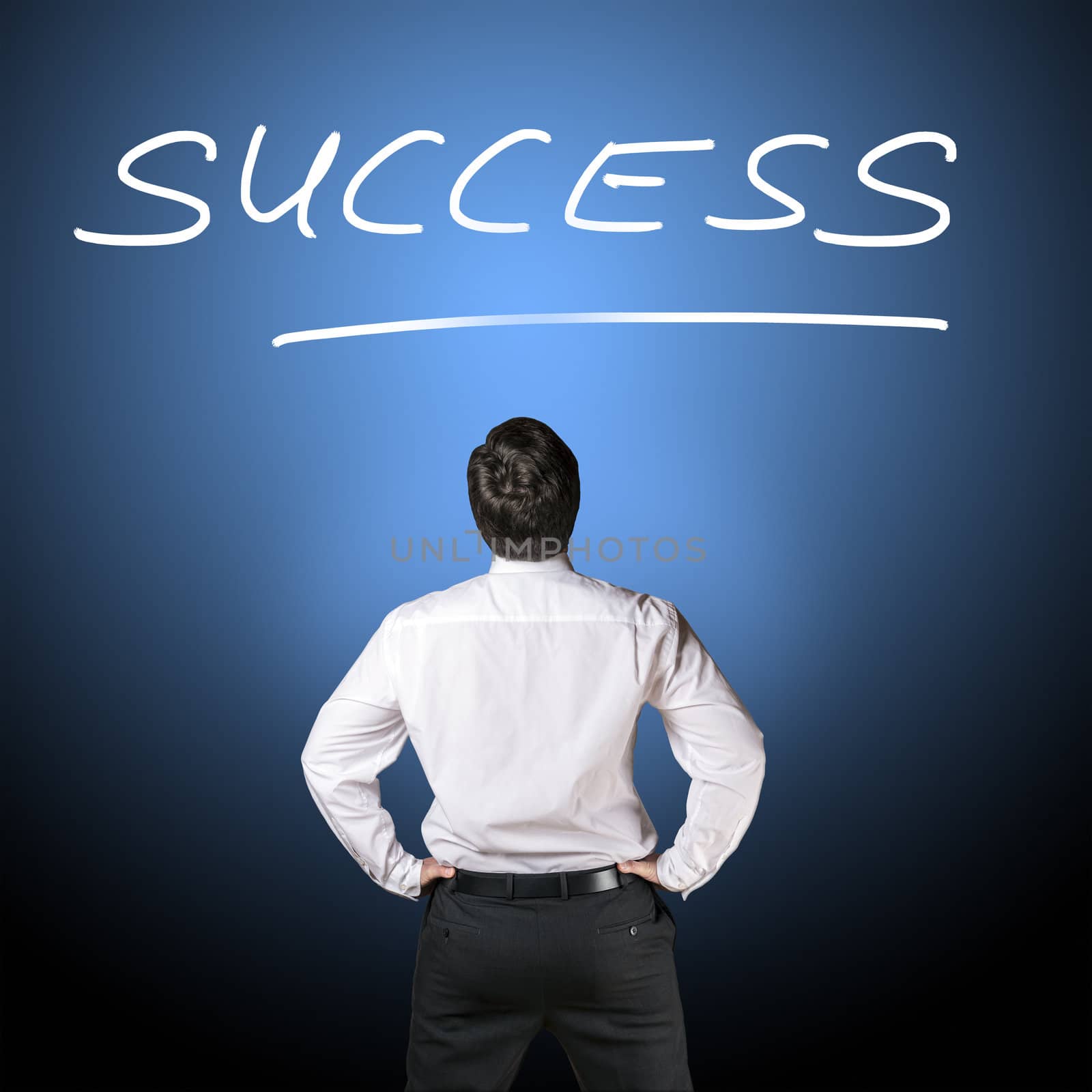 Backside of a business man in black business trousers and white business shirt who is looking to lettering "success" with a blue-black background