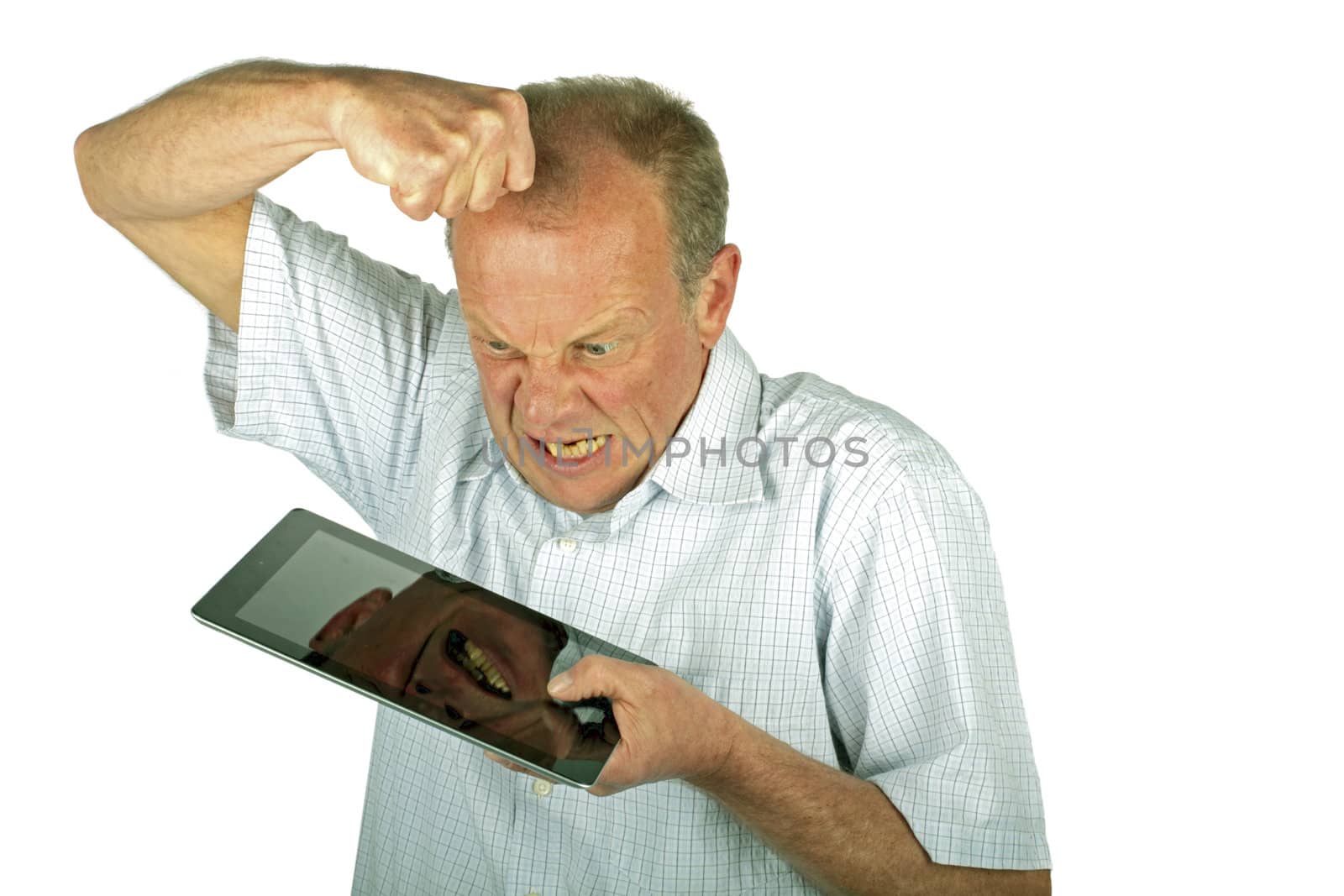 Angry man destroying his tablet computer