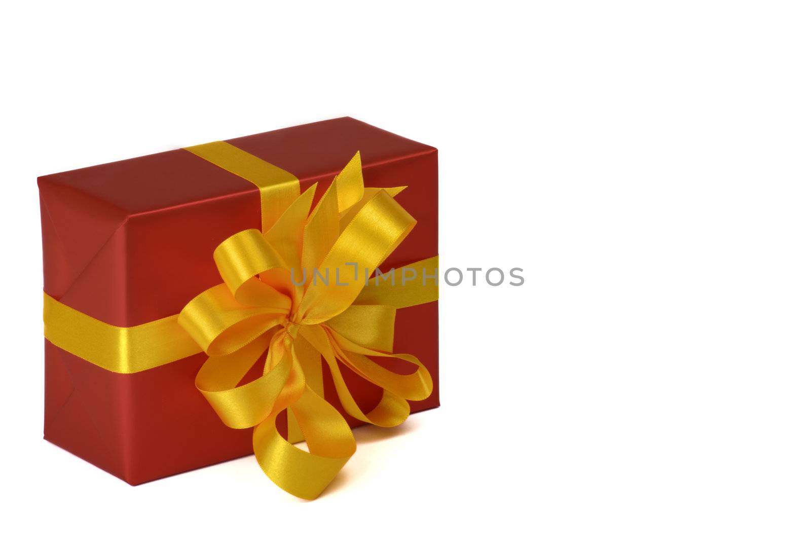 gift with gold ribbon in red paper on white underground