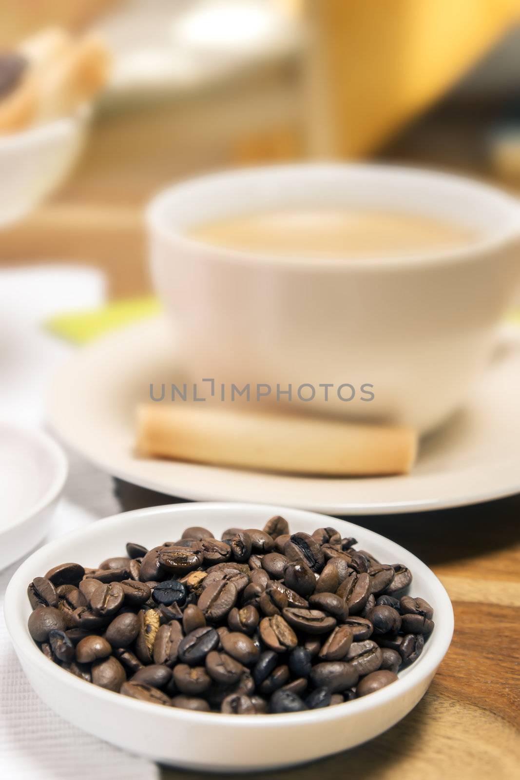 Coffee beans with cup of coffee