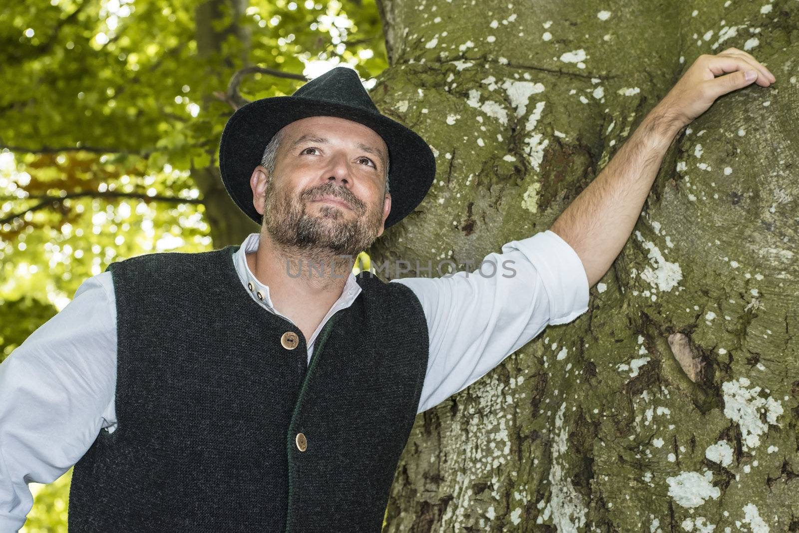 Man with Bavarian tradition standing in a forest