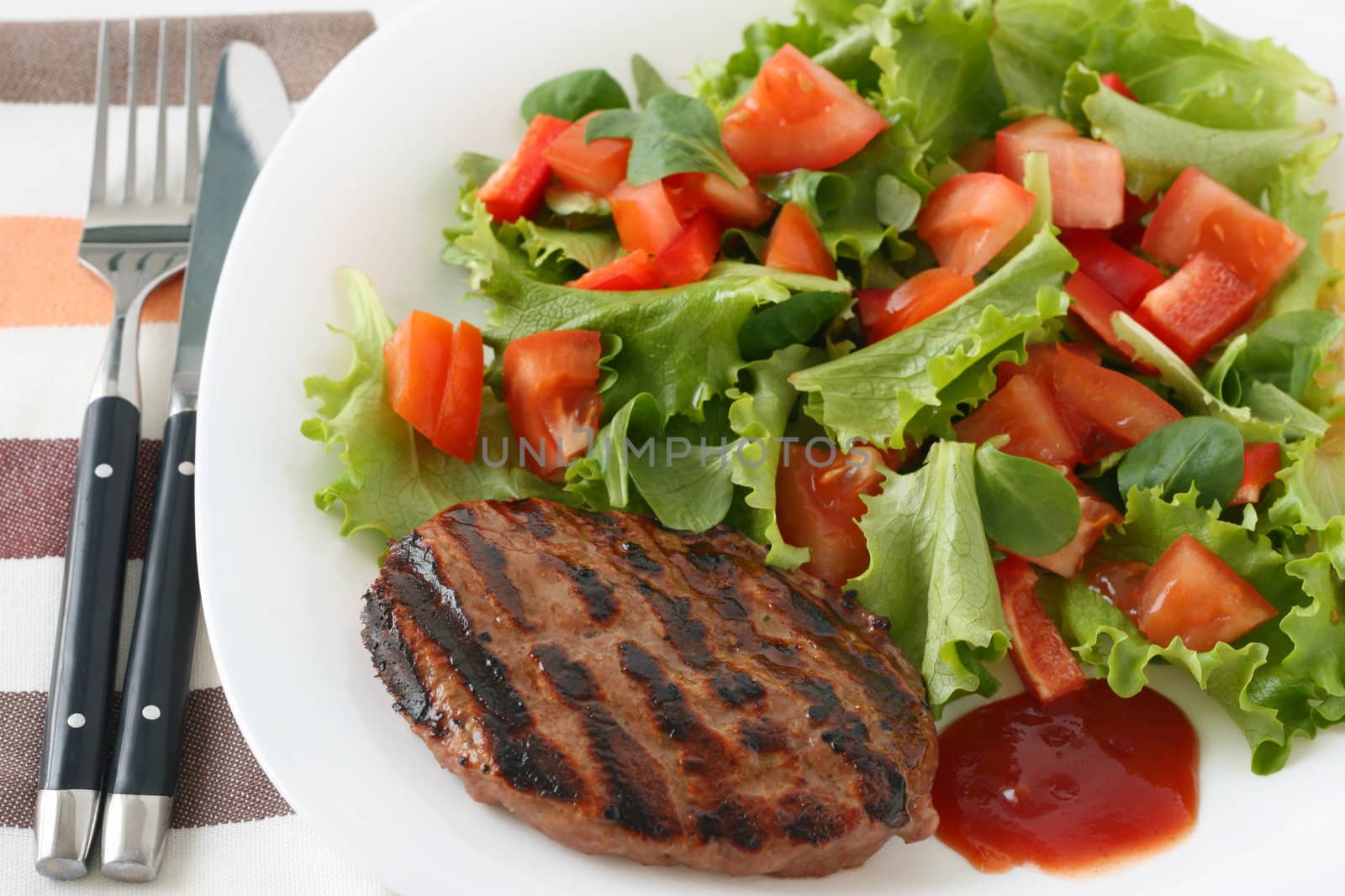 grilled hamburger with salad by nataliamylova