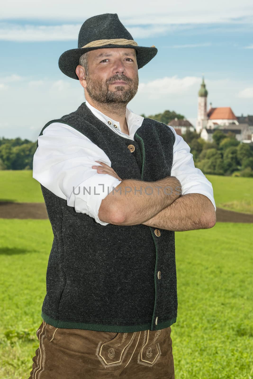 Bavarian traditional man in front of monestary Andechs on a sunny day