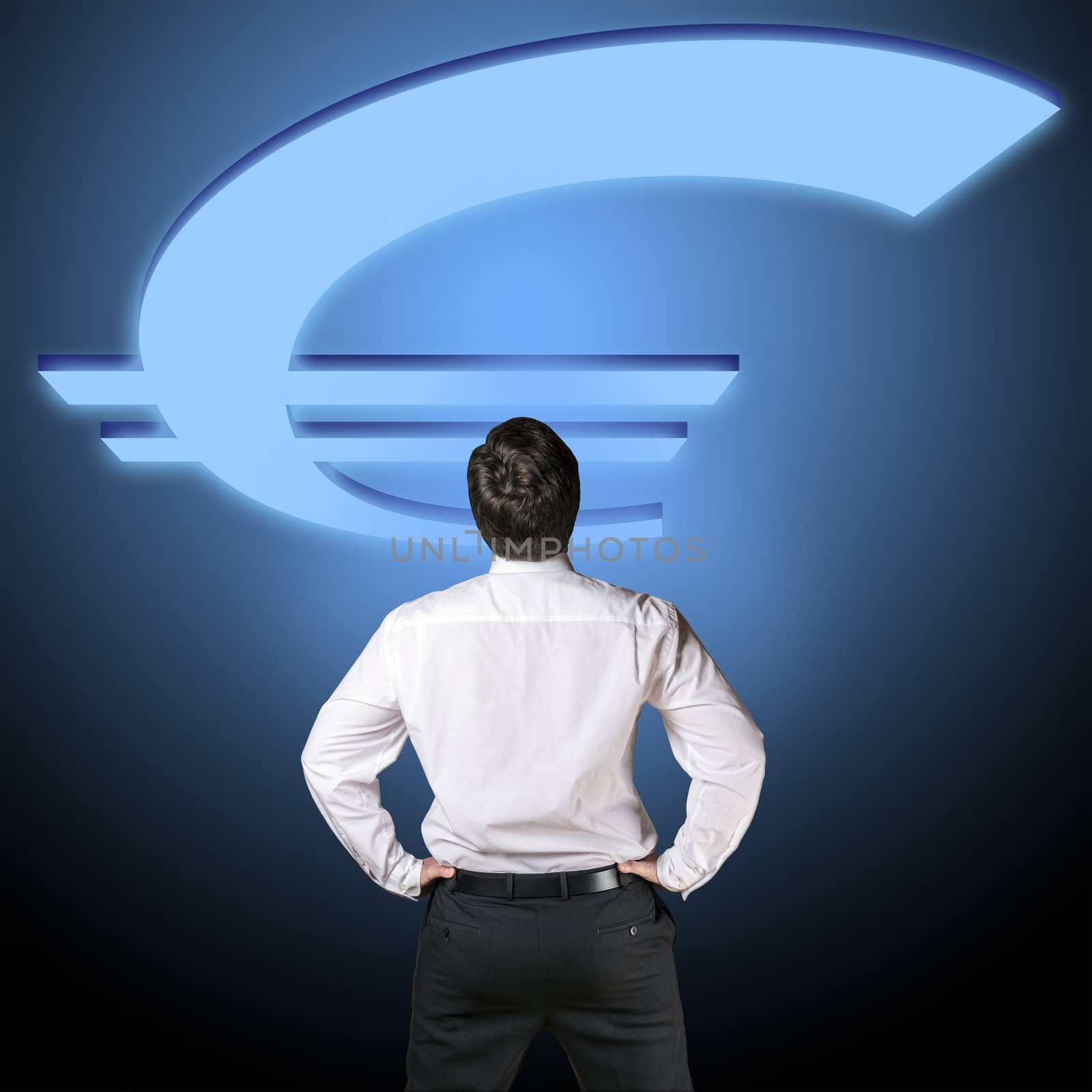Backside of a business man in black business trousers and white business shirt who is looking to a euro blue illuminated euro sign with a blue-black background