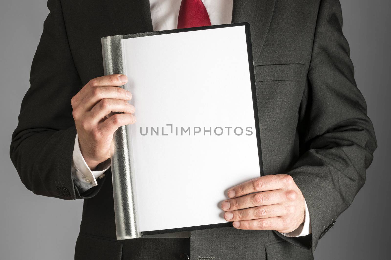 cutout of well dressed business man with red tie and black suite who is holding a folder