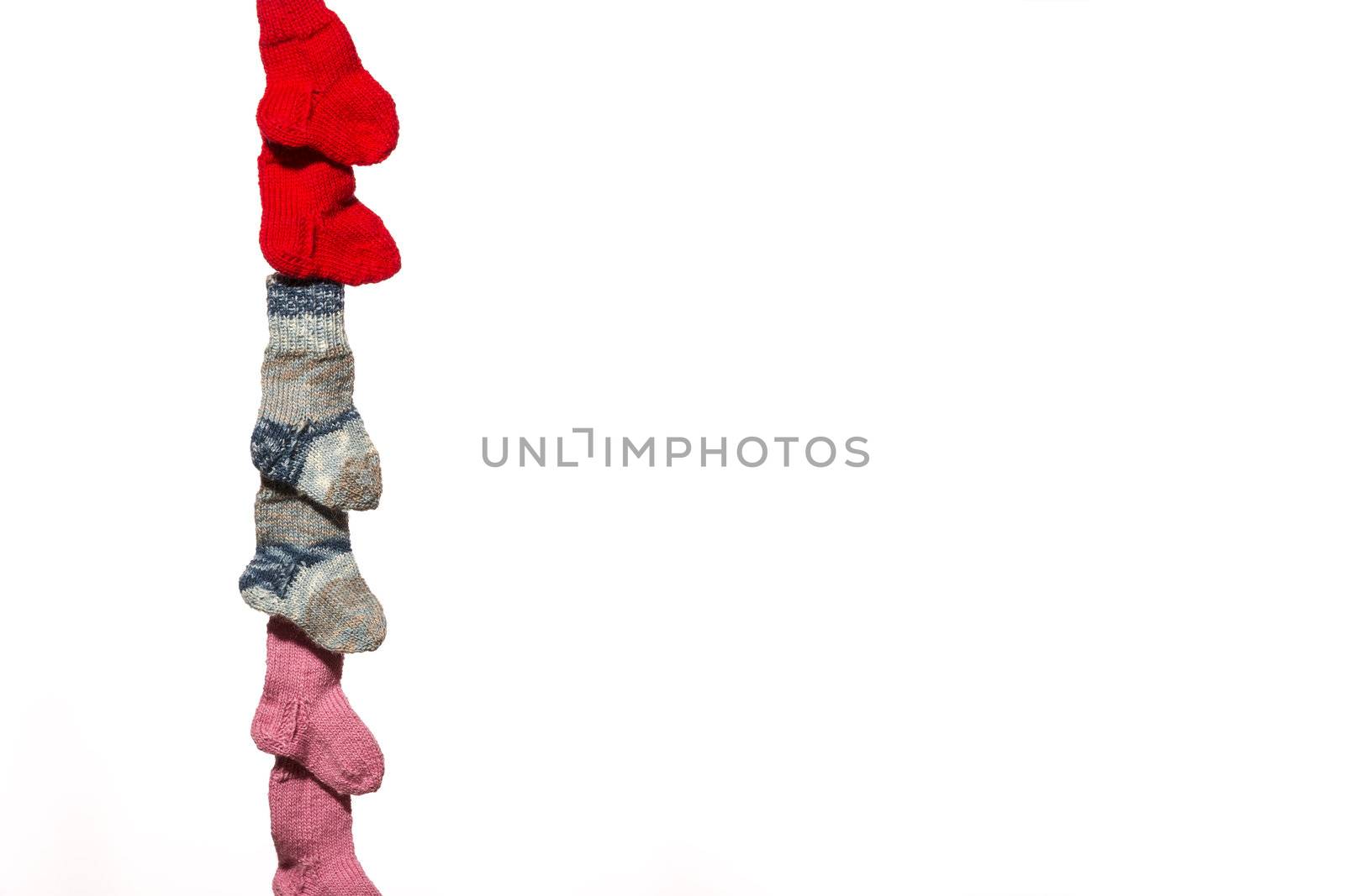 Three pairs of baby socks in front of a white background