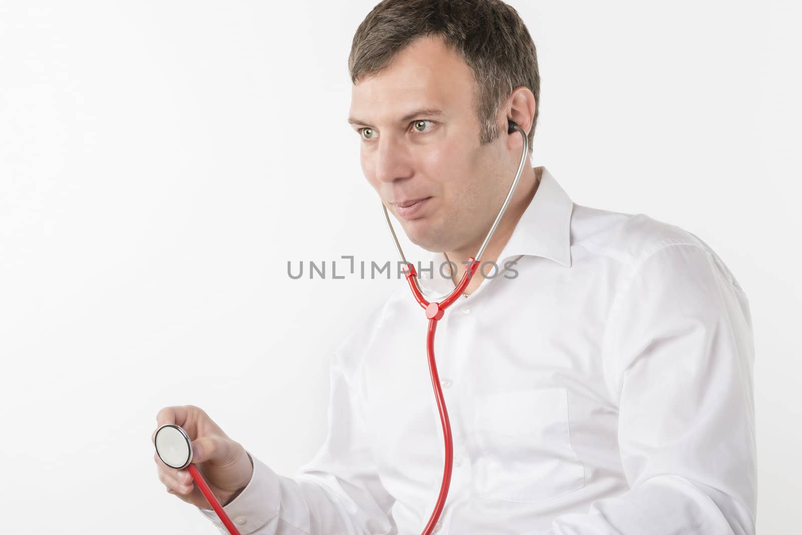 Man in white shirt is holding a red stetoscope on white background