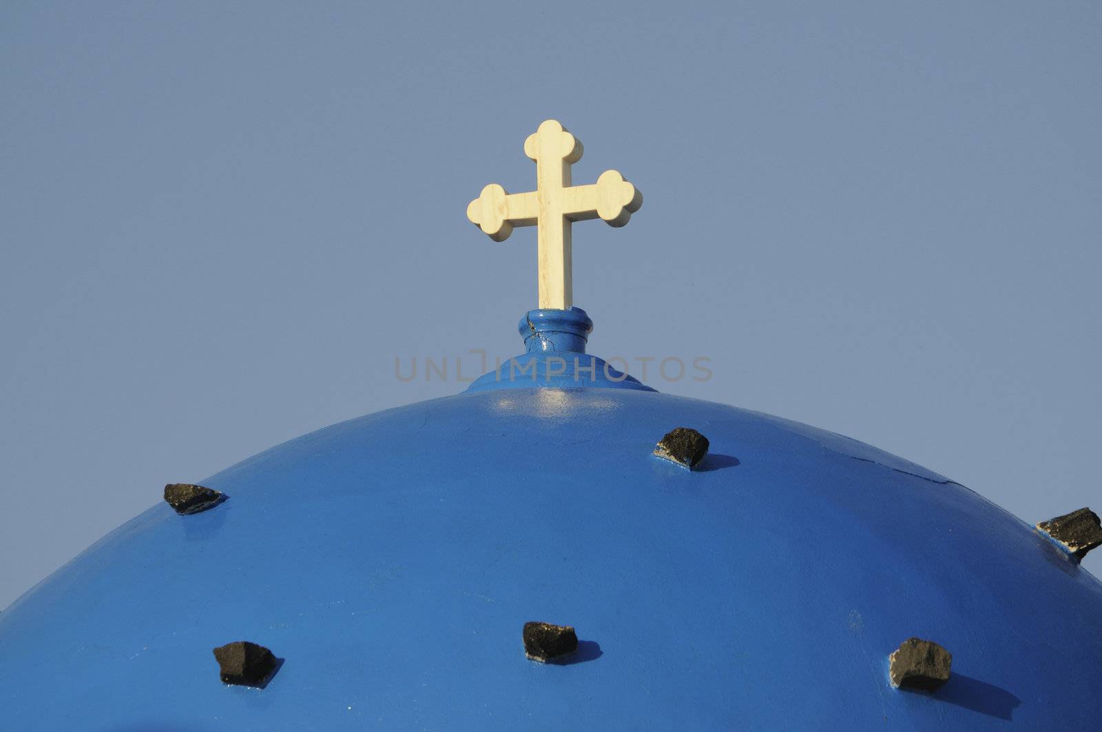 blue dome with cross of a church on Santorini