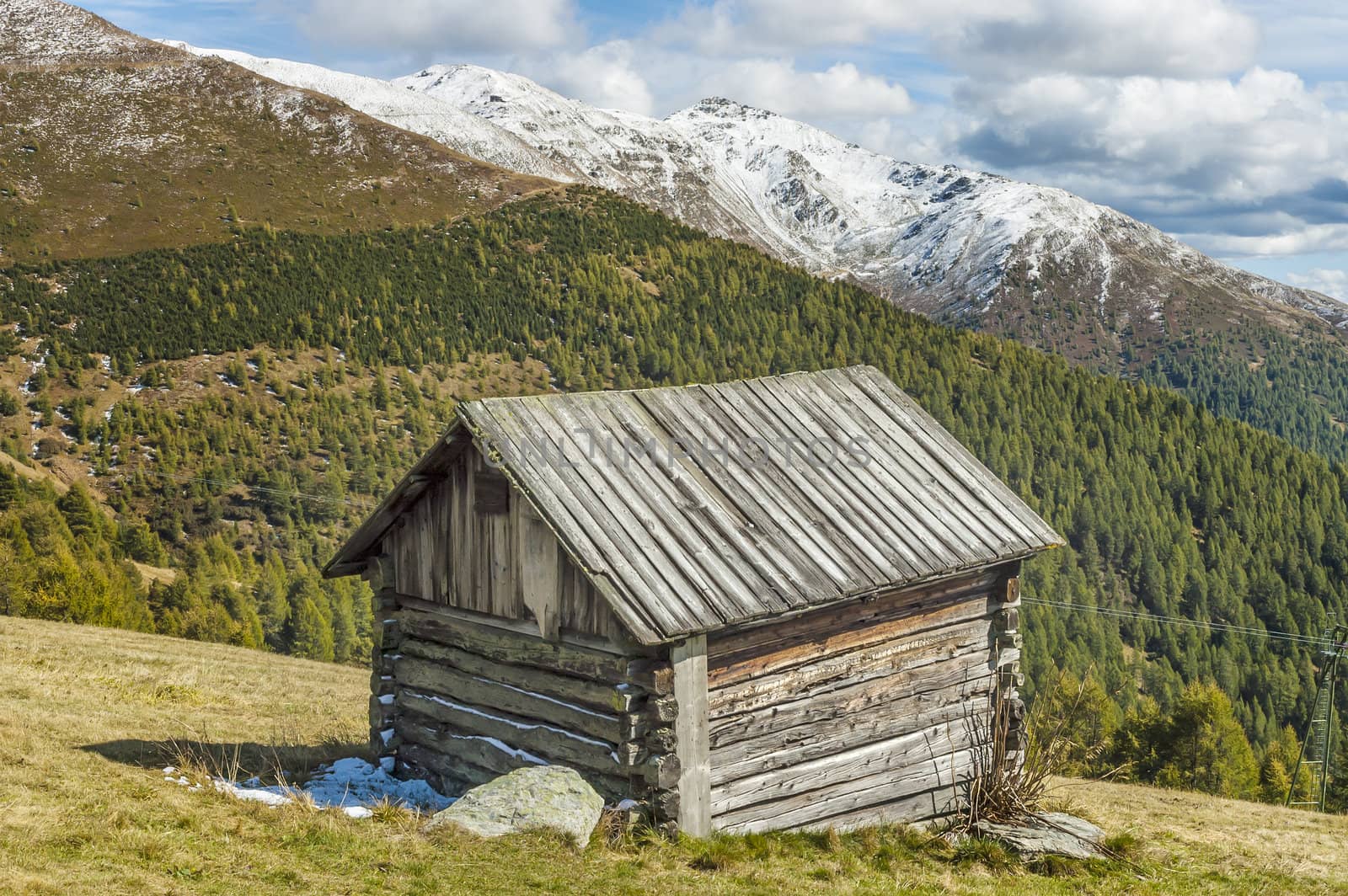 Cottage in the high mountains in South Tyrol on a sunny day with clouds