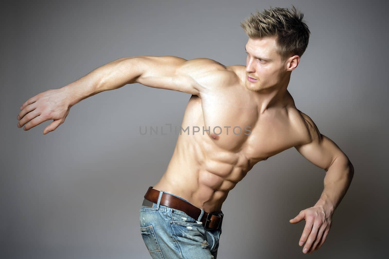 Young and blond athletic man is turning around