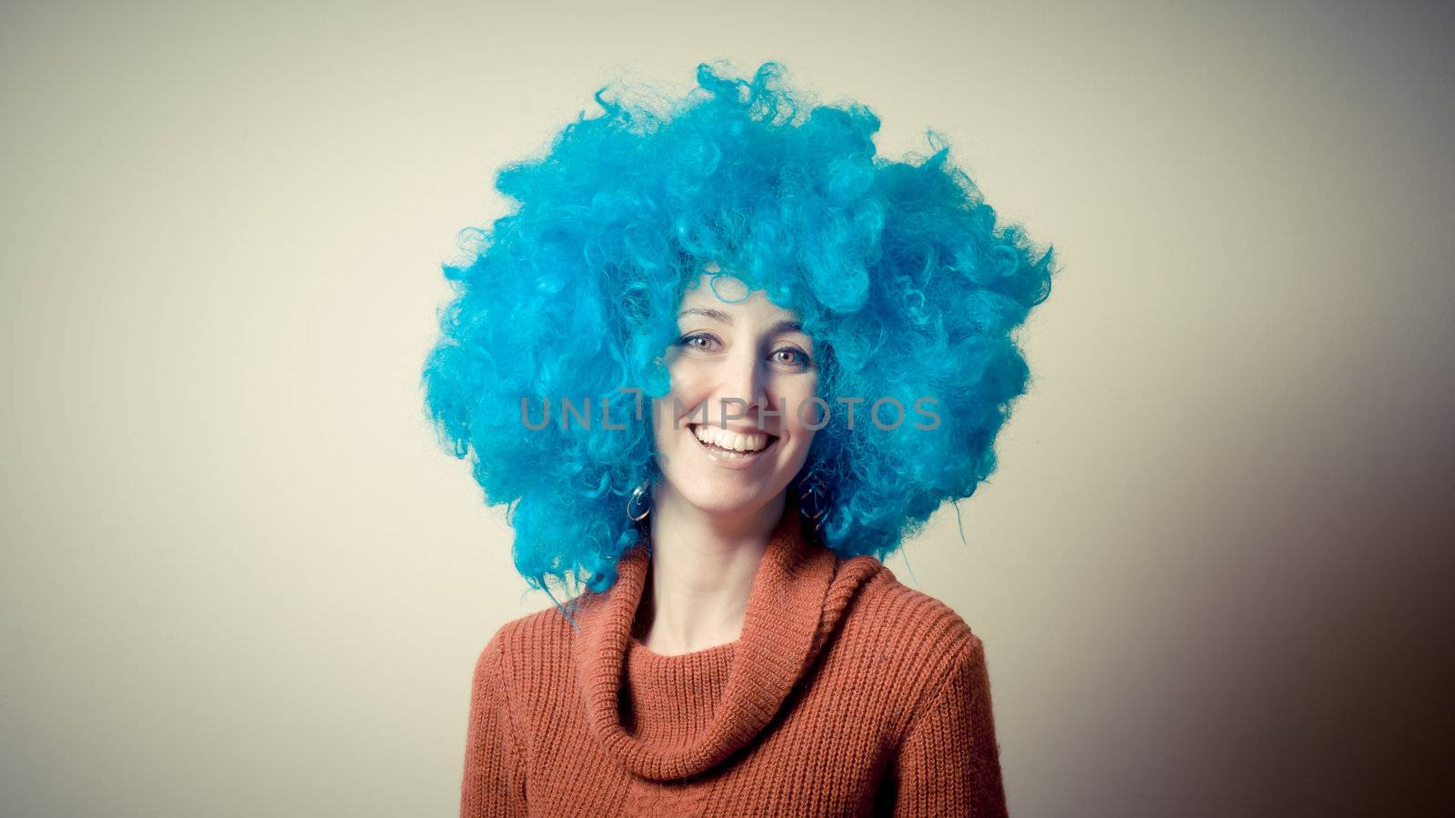 beautiful girl with curly blue wig and turtleneck on white background