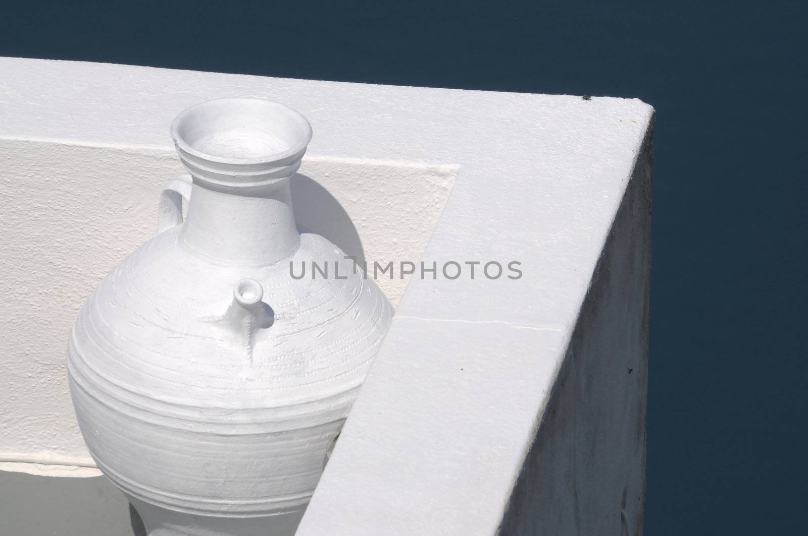White vase in front of a white wall on Santorini