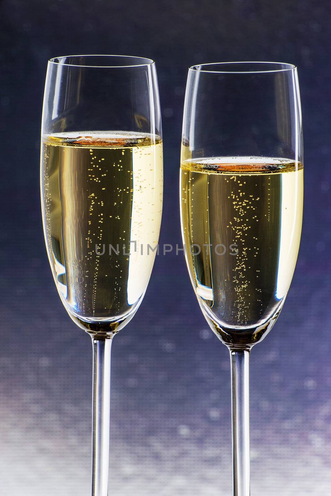 Two glasses of champagne with silver blue background