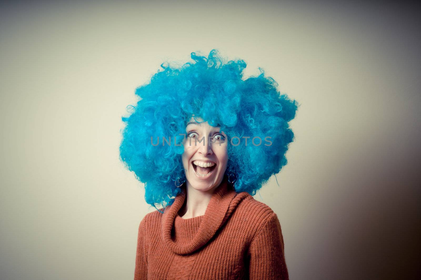 beautiful girl with curly blue wig and turtleneck on white background