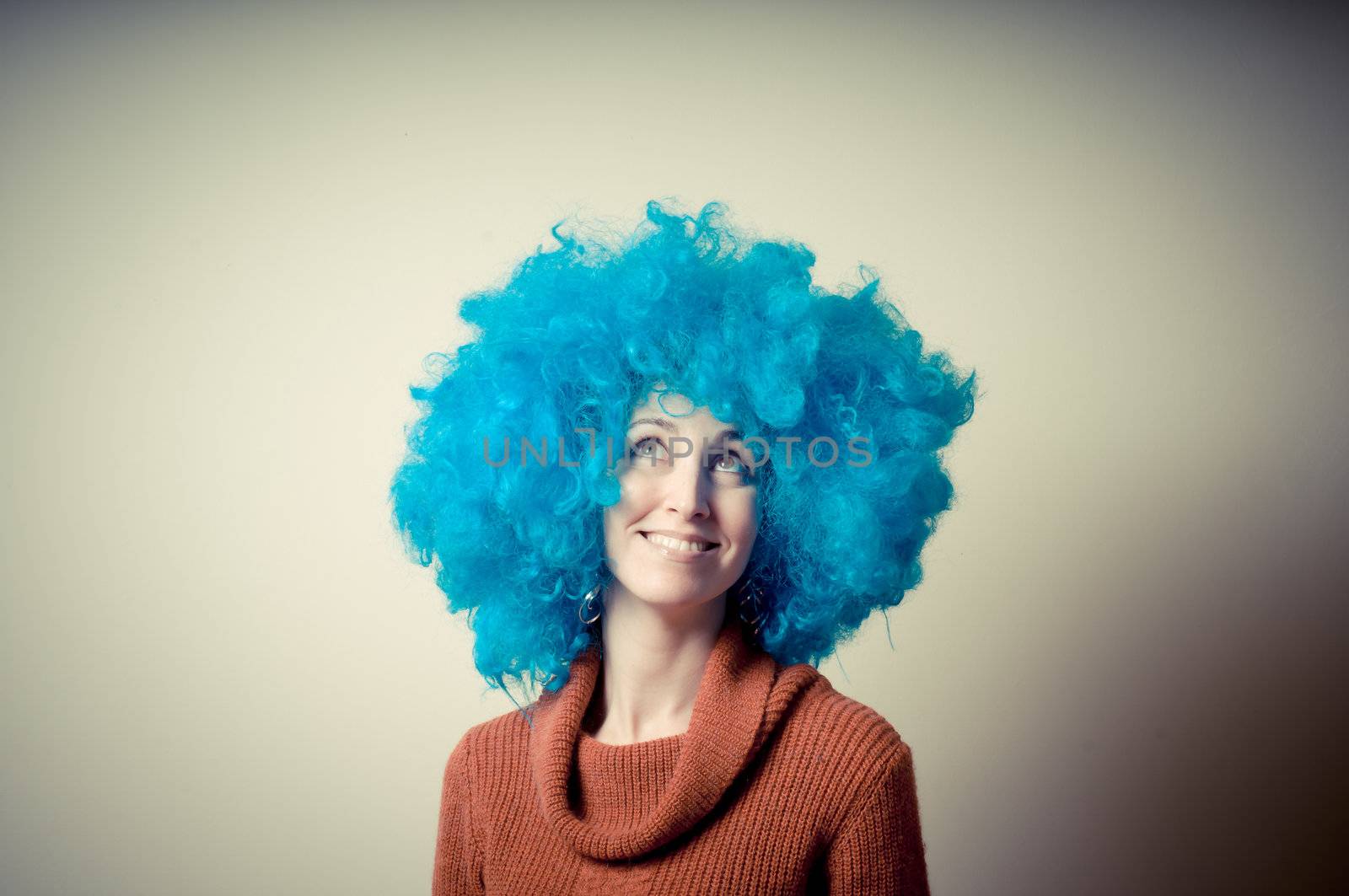 beautiful girl with curly blue wig and turtleneck on white background