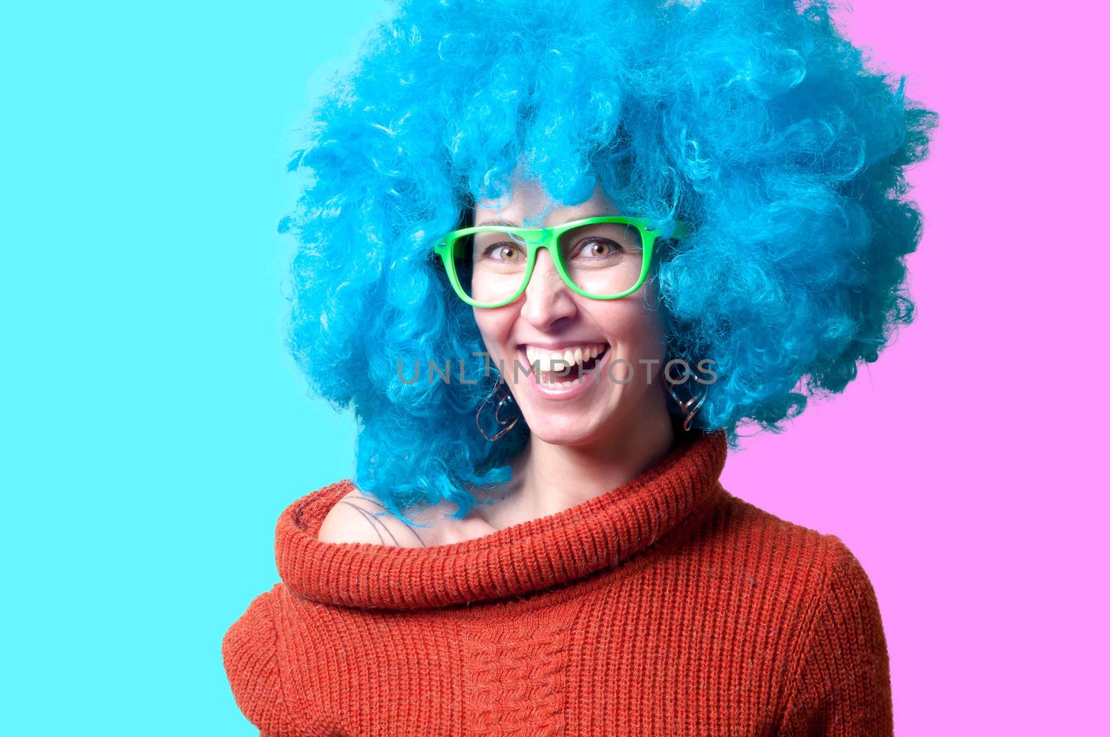 beautiful girl with curly blue wig and turtleneck on colorful background