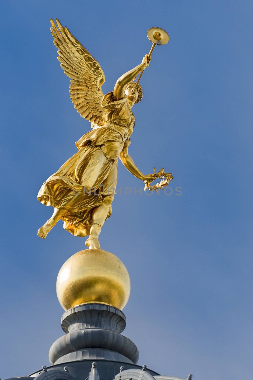 Golden angel with trumpet on the top of historic house in Dresden