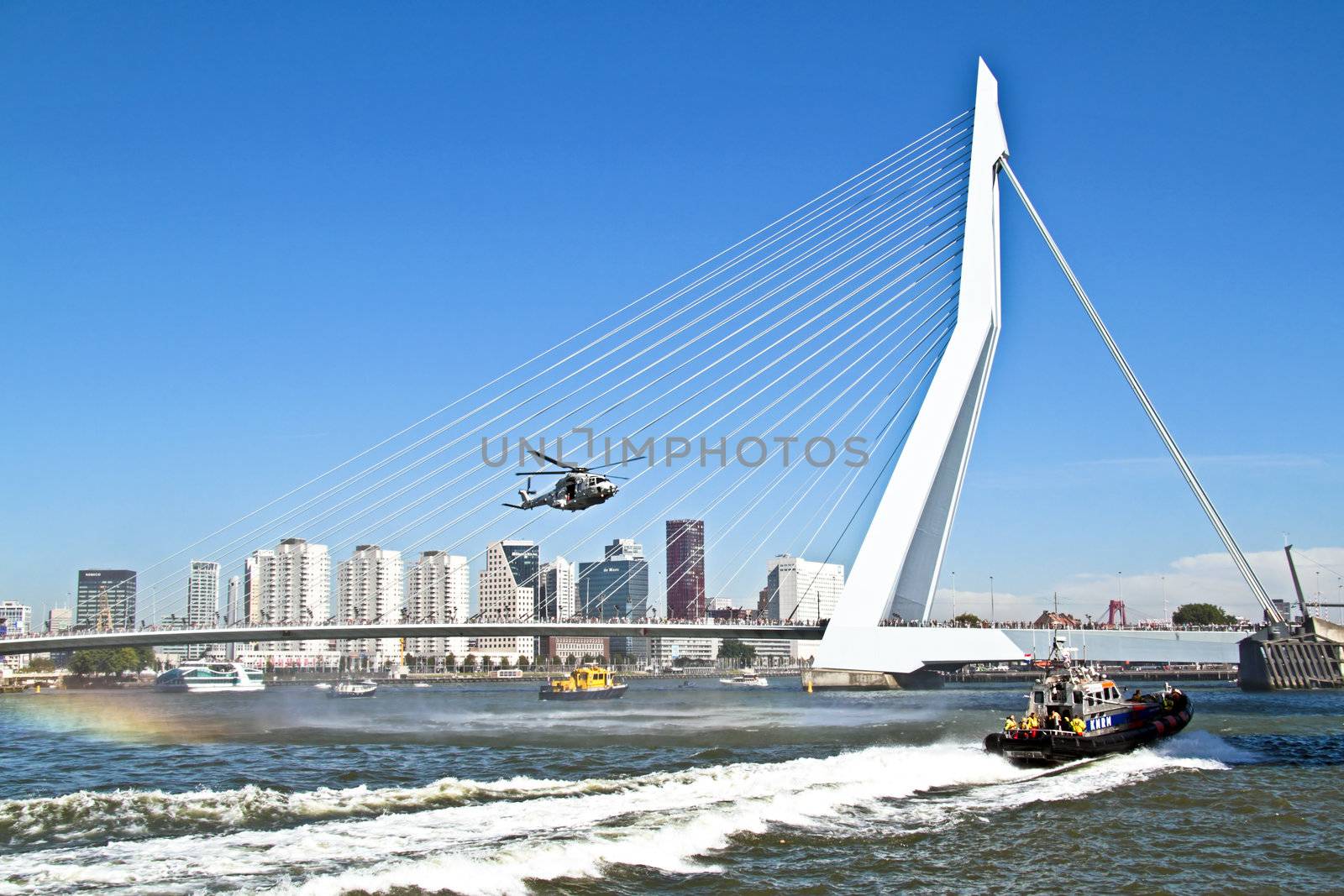 ROTTERDAM, NETHERLANDS - SEPTEMBER 09: Army helicopter is flying in front of the erasmus bridge during the world harbor days on 9 september 2012 Rotterdam the Netherlands