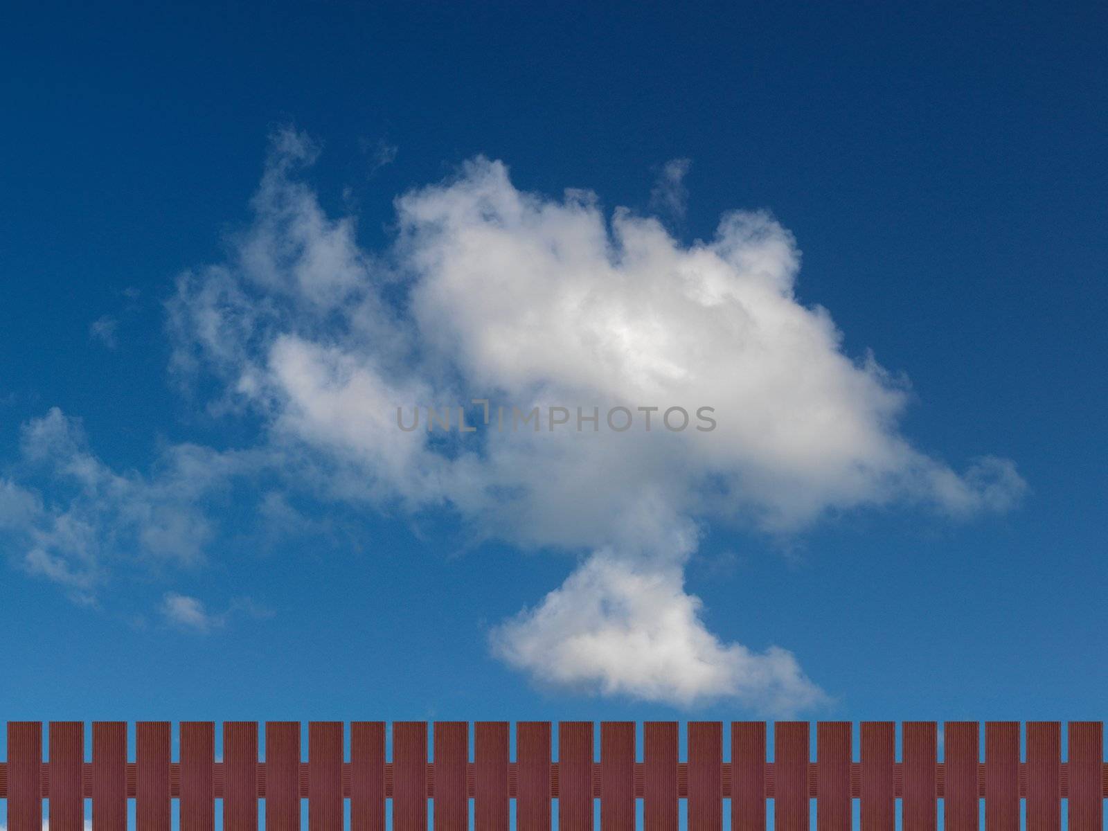 A morning shot of a cloudy blue sky and a picket fence