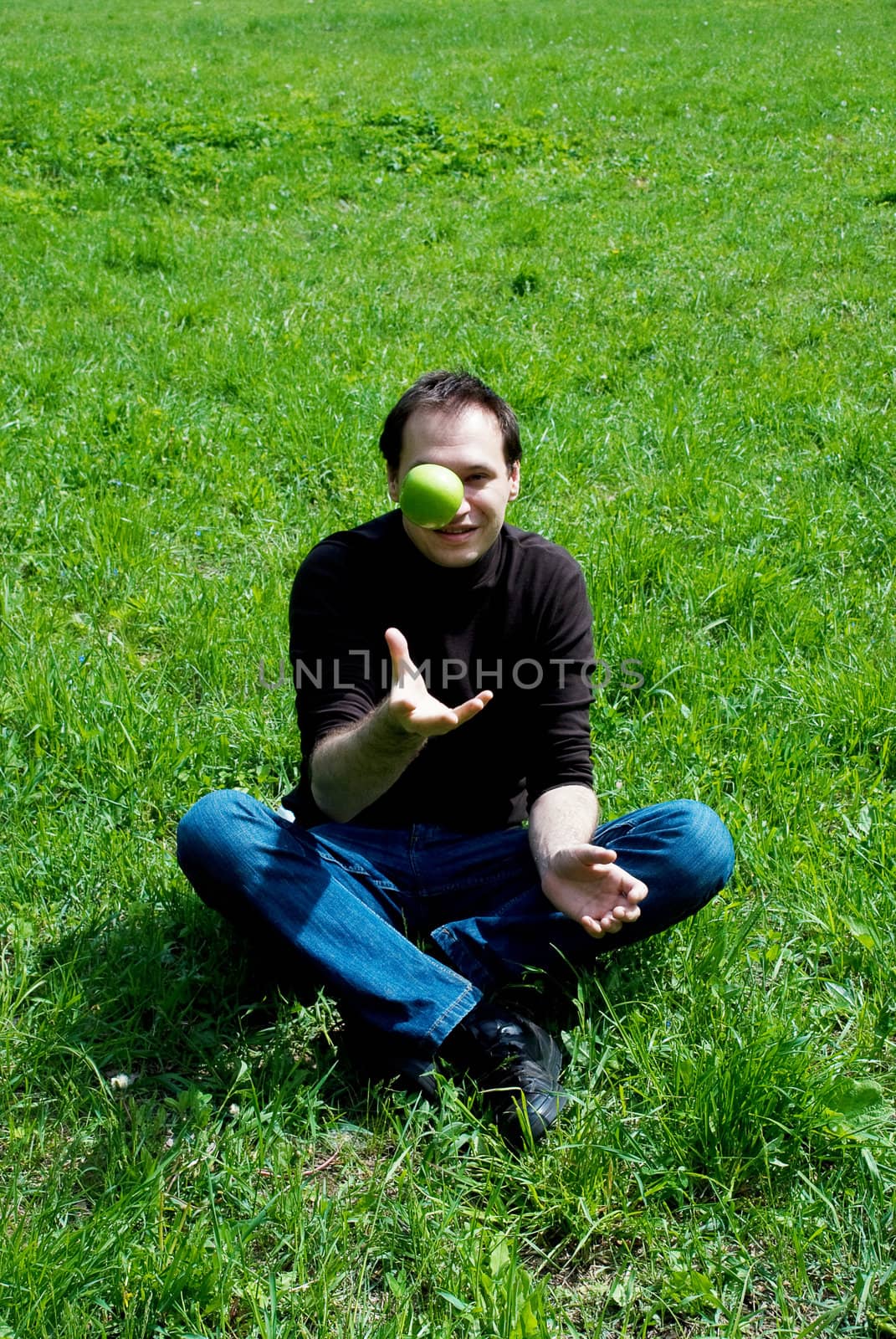 man sitting on green grass