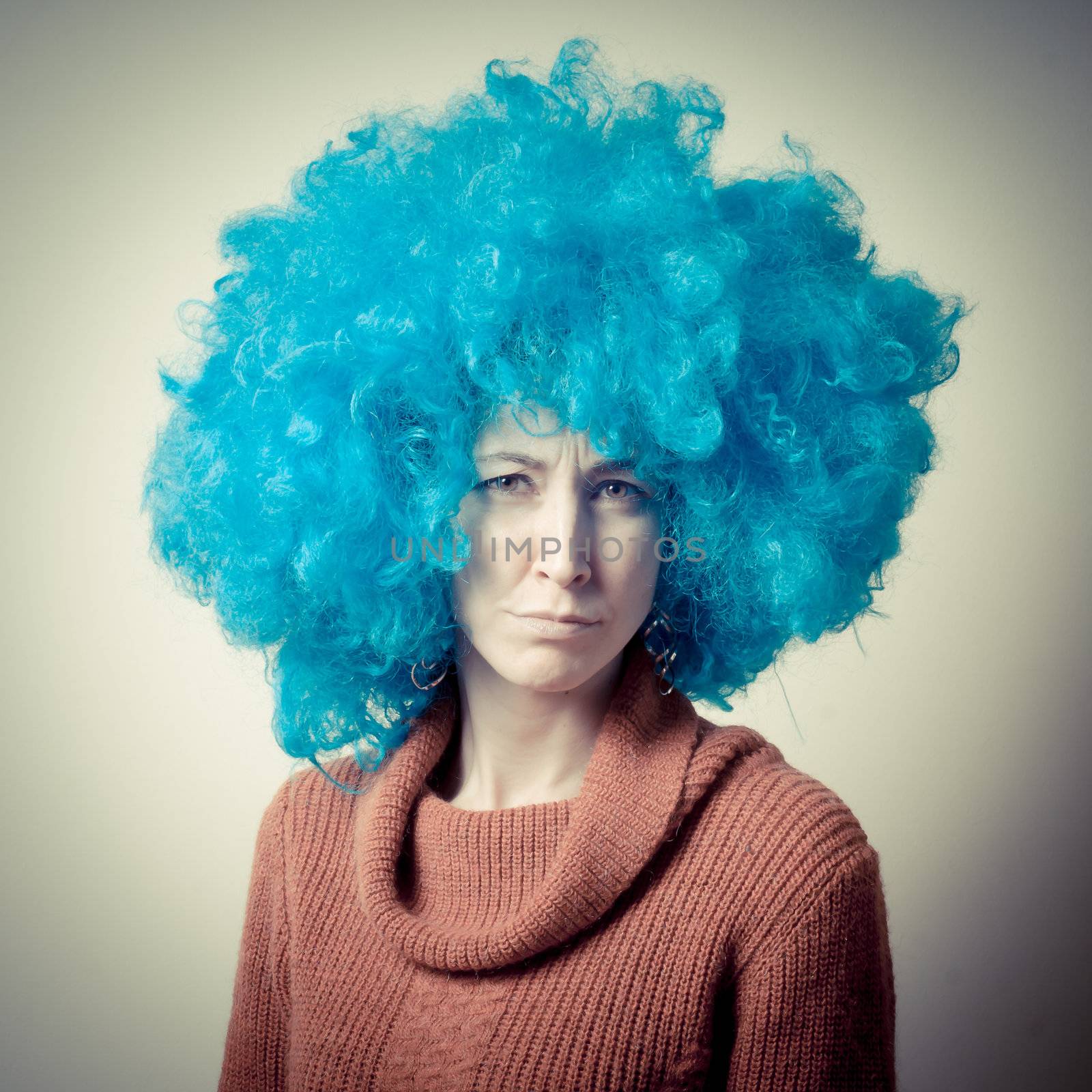 beautiful girl with curly blue wig and turtleneck on white background