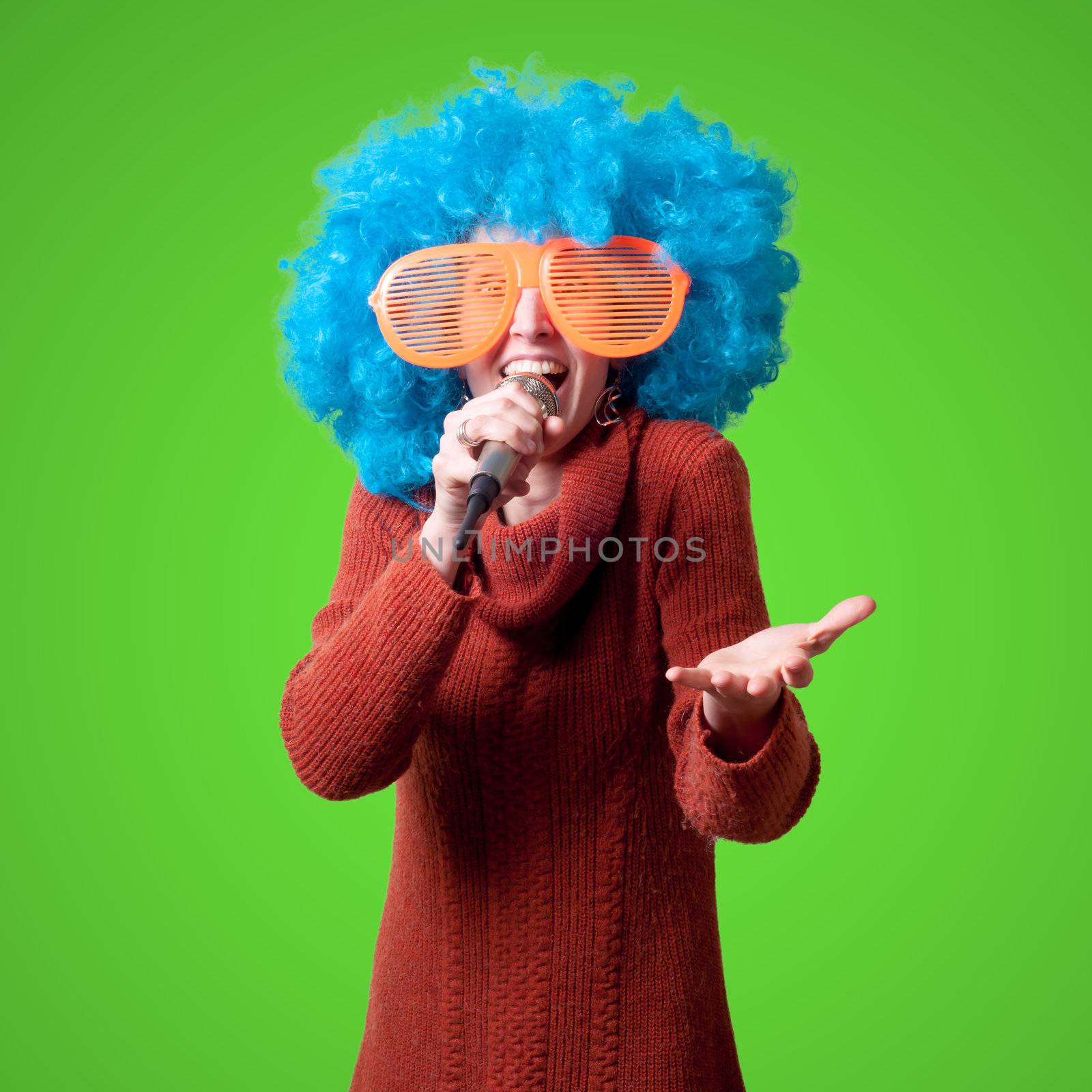 beautiful girl with curly blue wig and turtleneck on green background