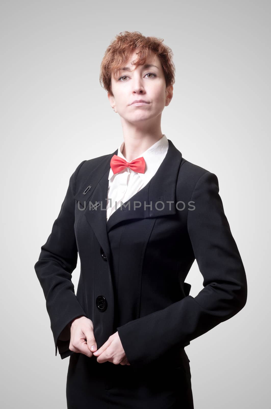 elegant businesswoman with bow tie on gray background
