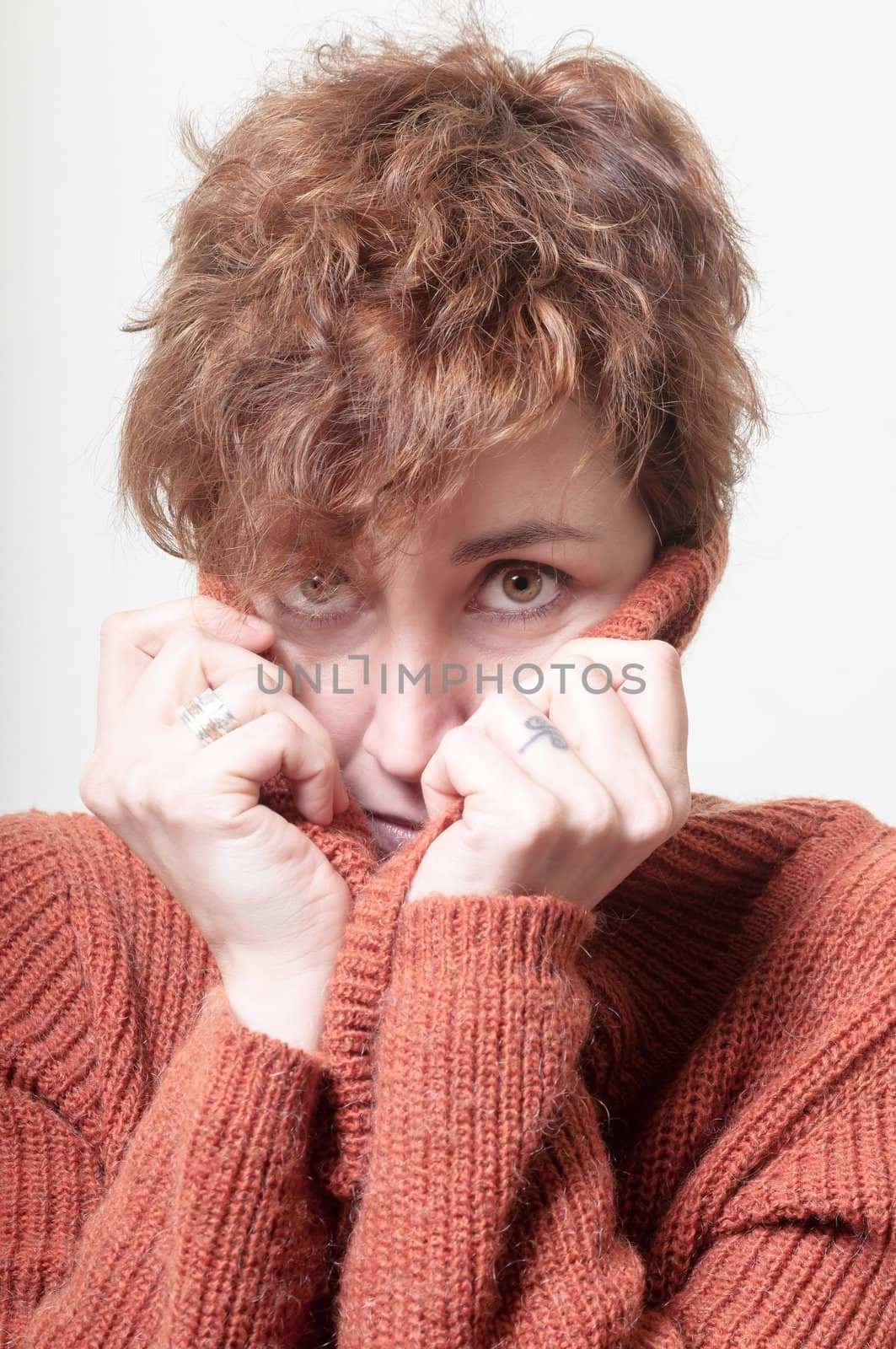 short hair girl cold with orange sweater on white background