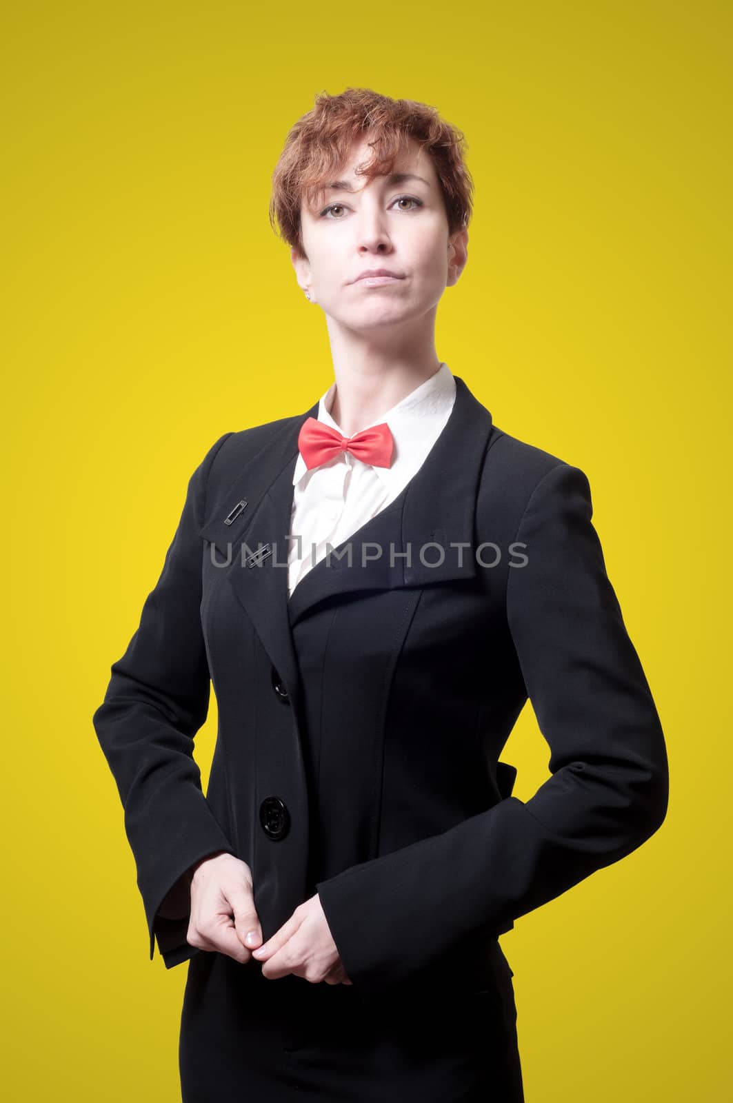 elegant businesswoman with bow tie on yellow background