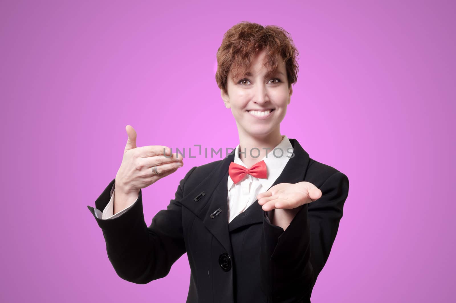 elegant businesswoman with bow tie showing on pink background