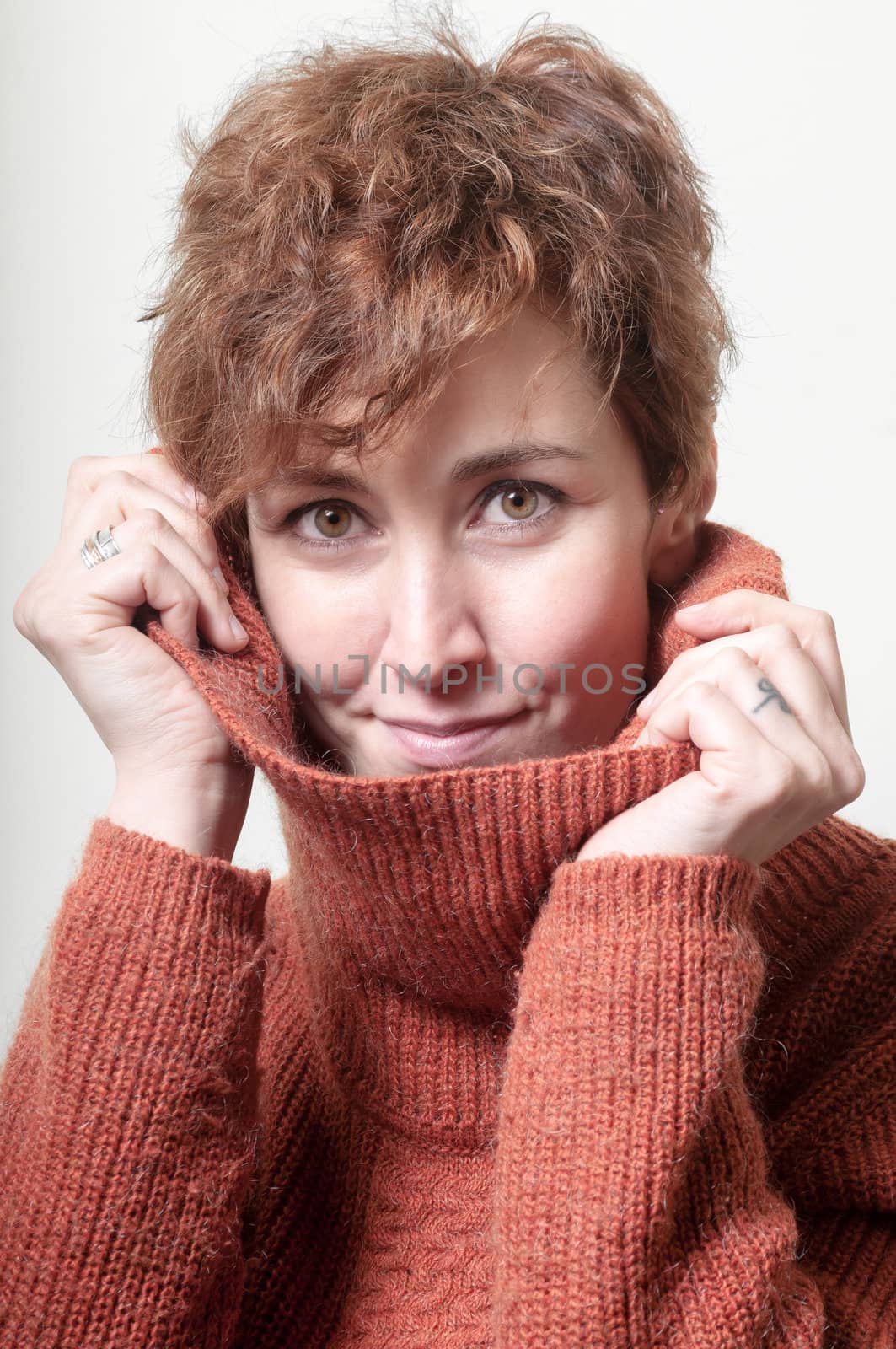 short hair girl cold with orange sweater on white background