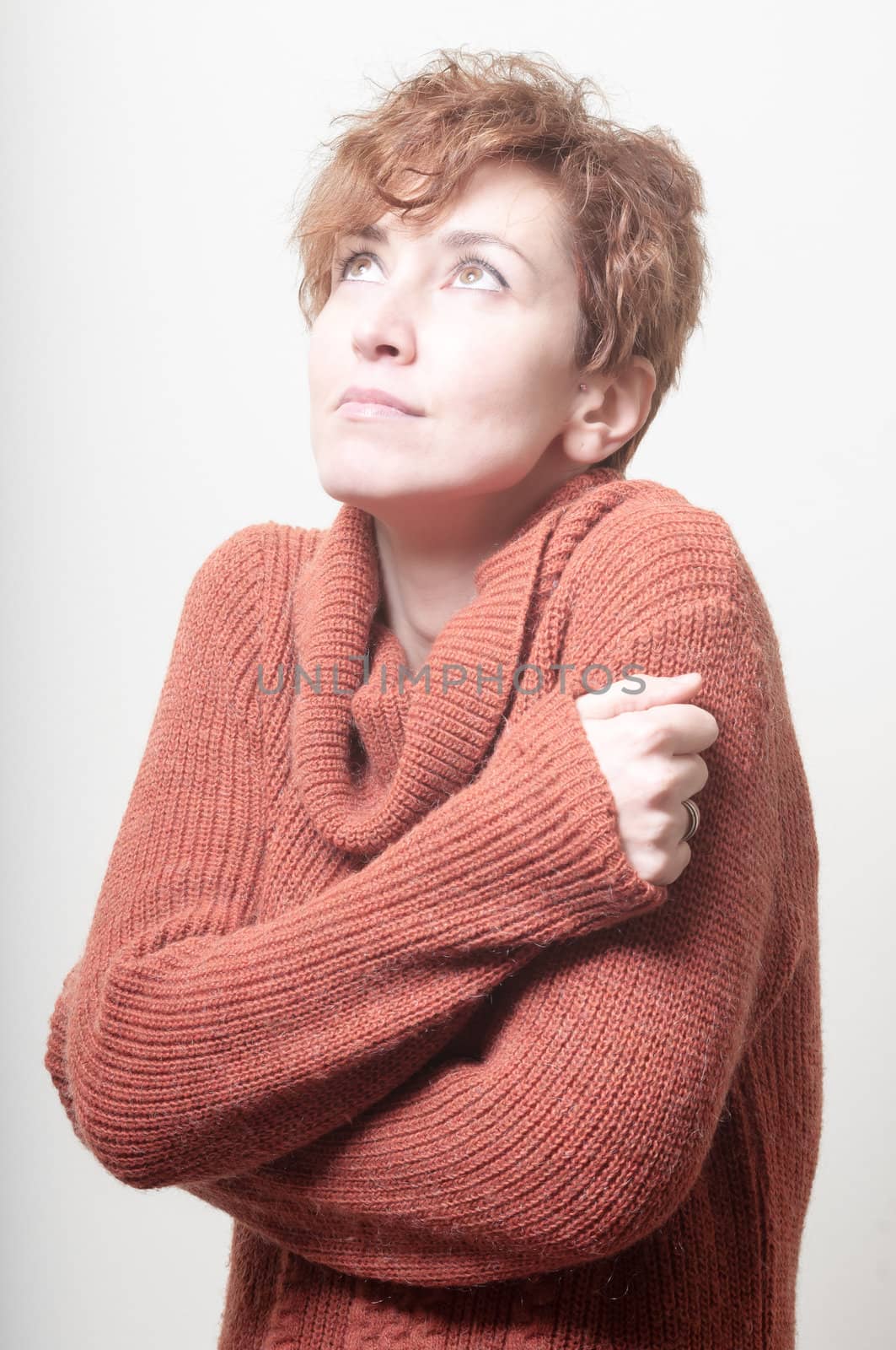 short hair girl cold with orange sweater on white background