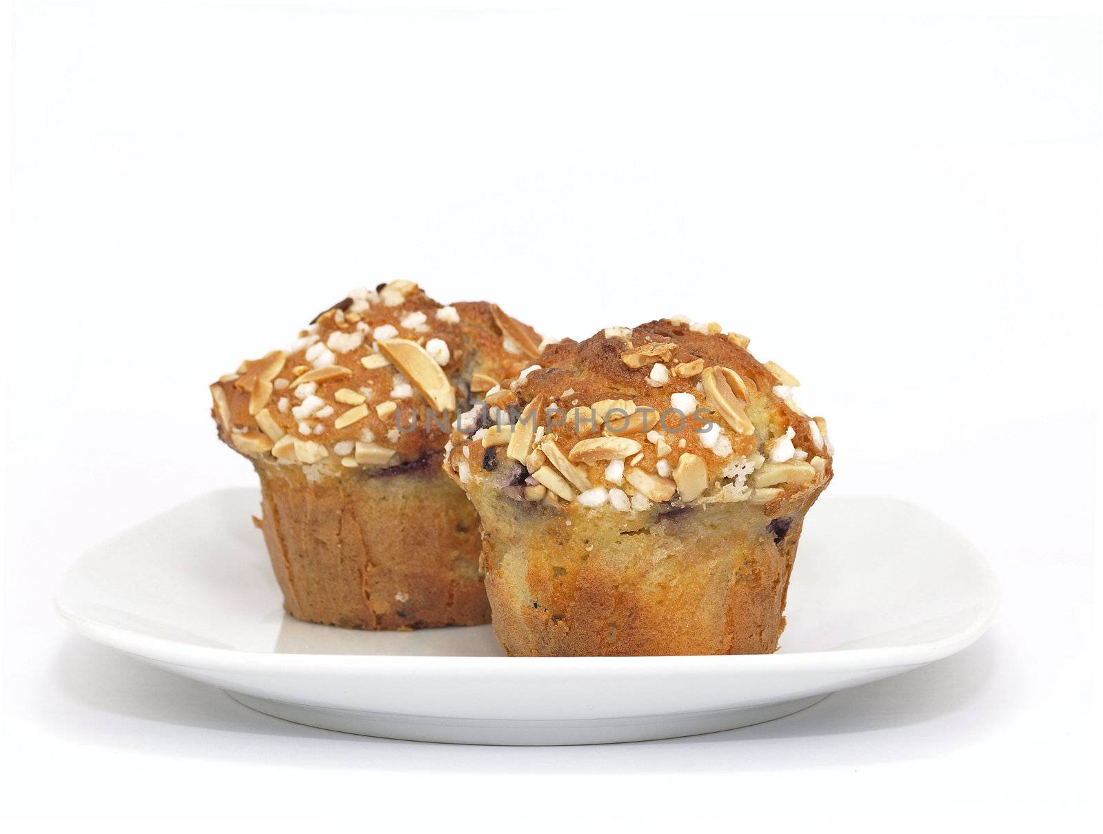 blueberry muffins with almond toppings on plate