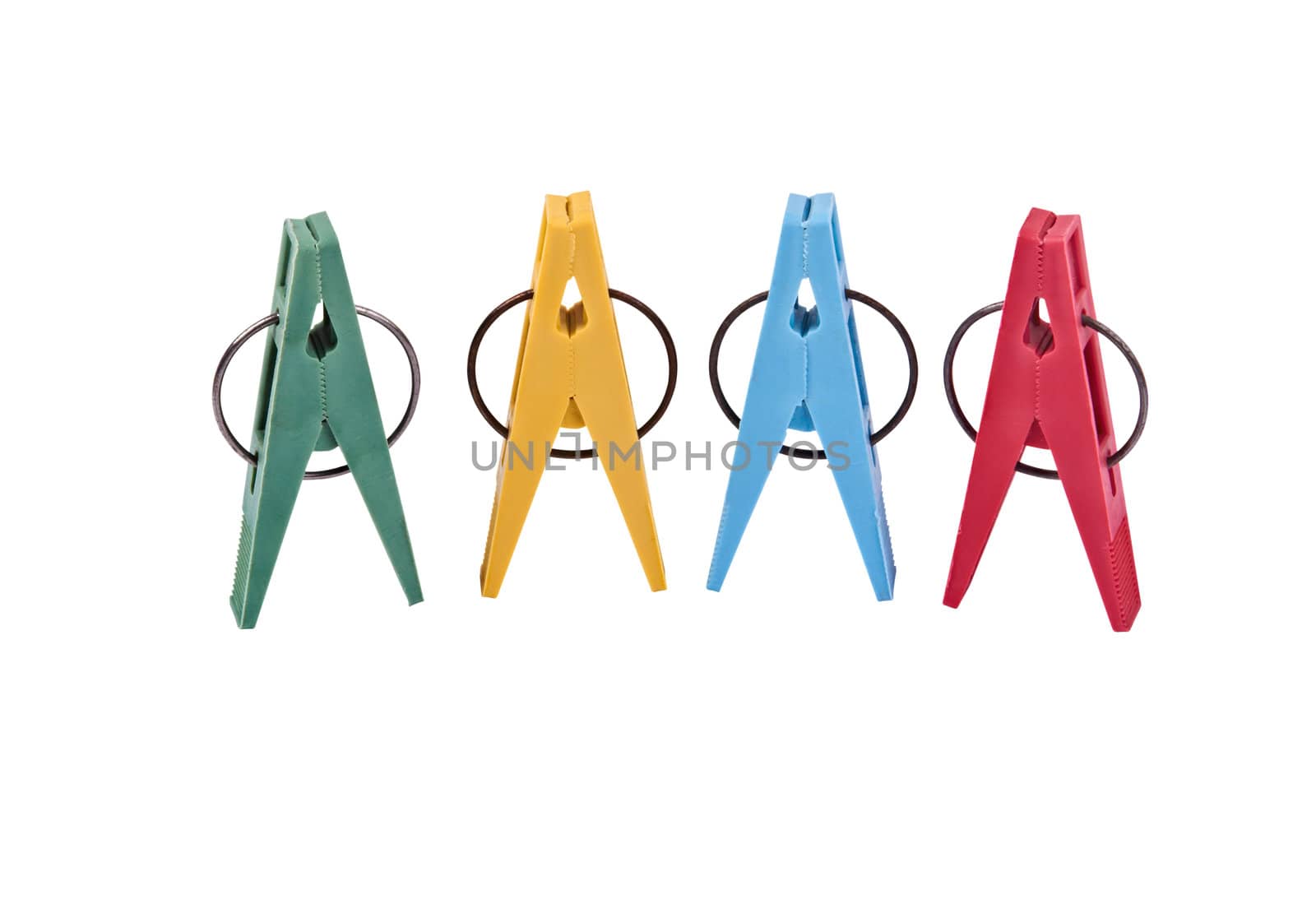 Closeup of four multi-colored plastic clothespegs located vertically. Image is isolated on white and the file includes a clipping path.