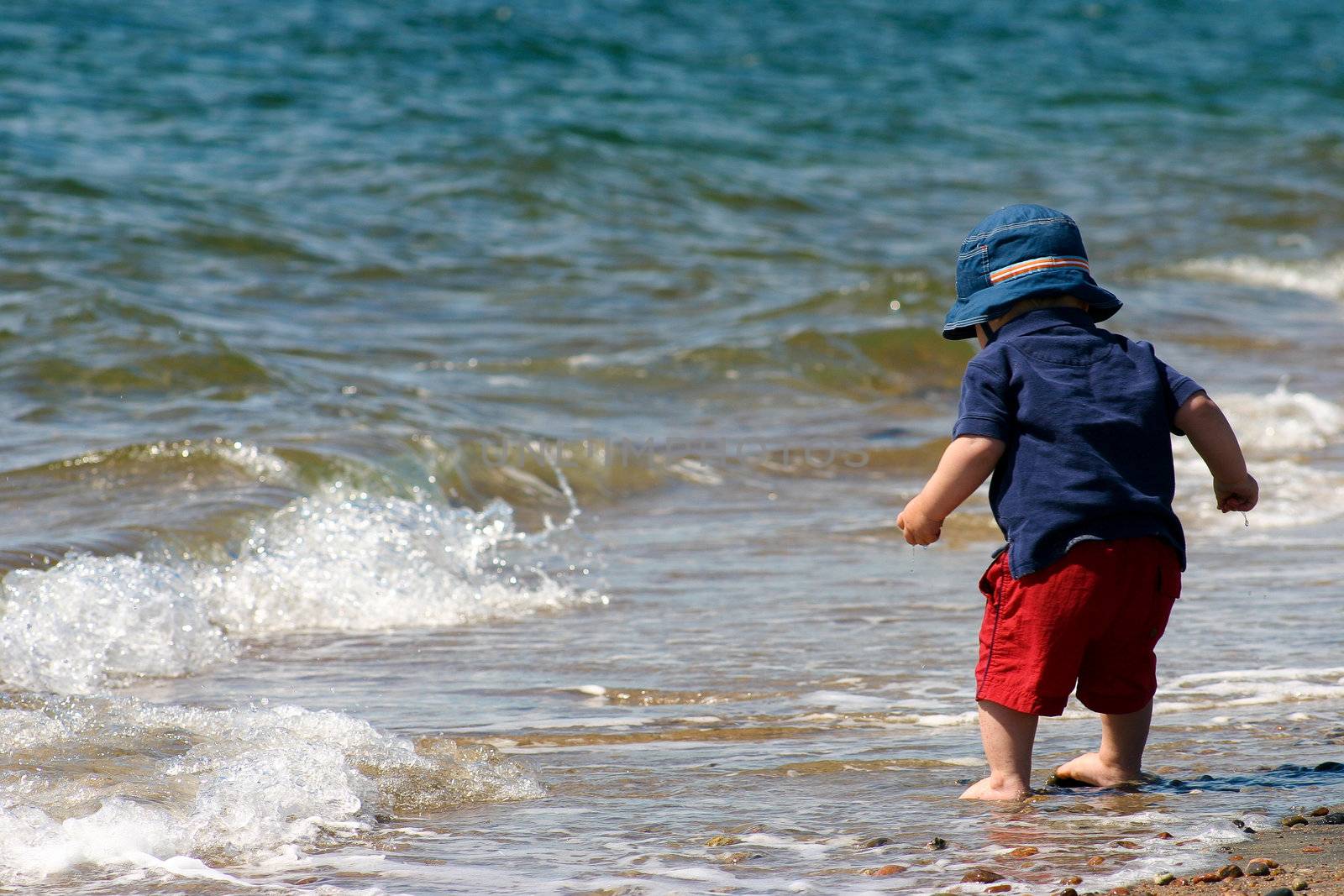 Little boy on the beach by Talanis