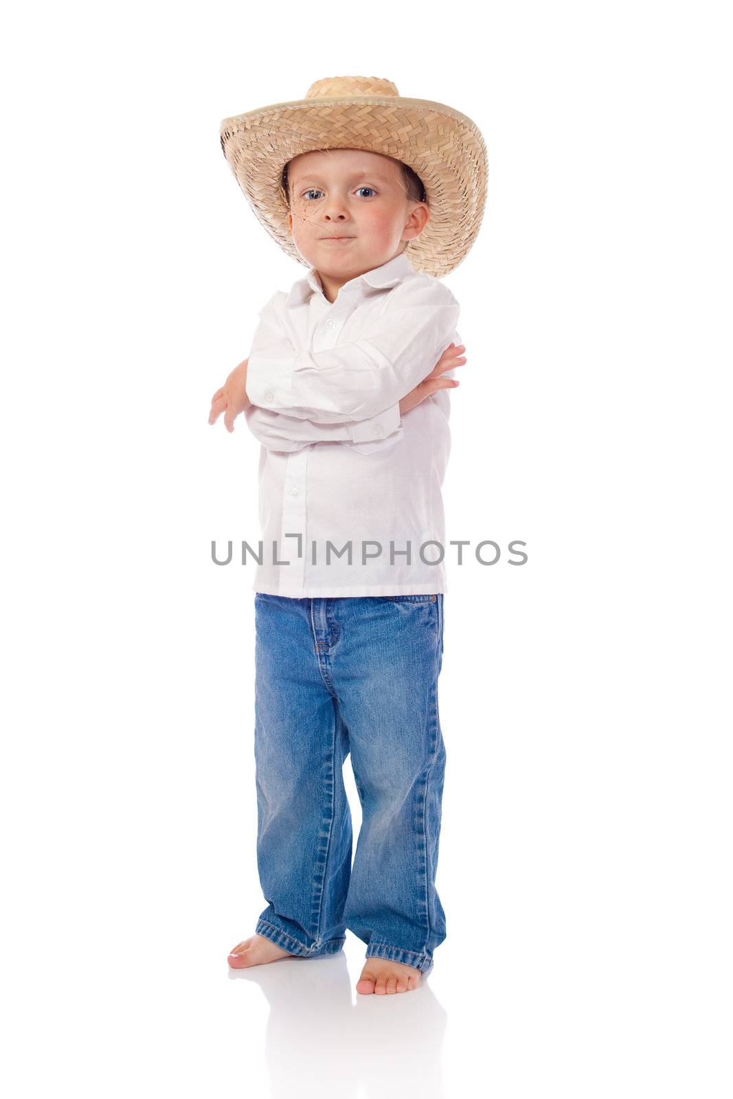 Little boy with a cowboy hat and straw in his mouth