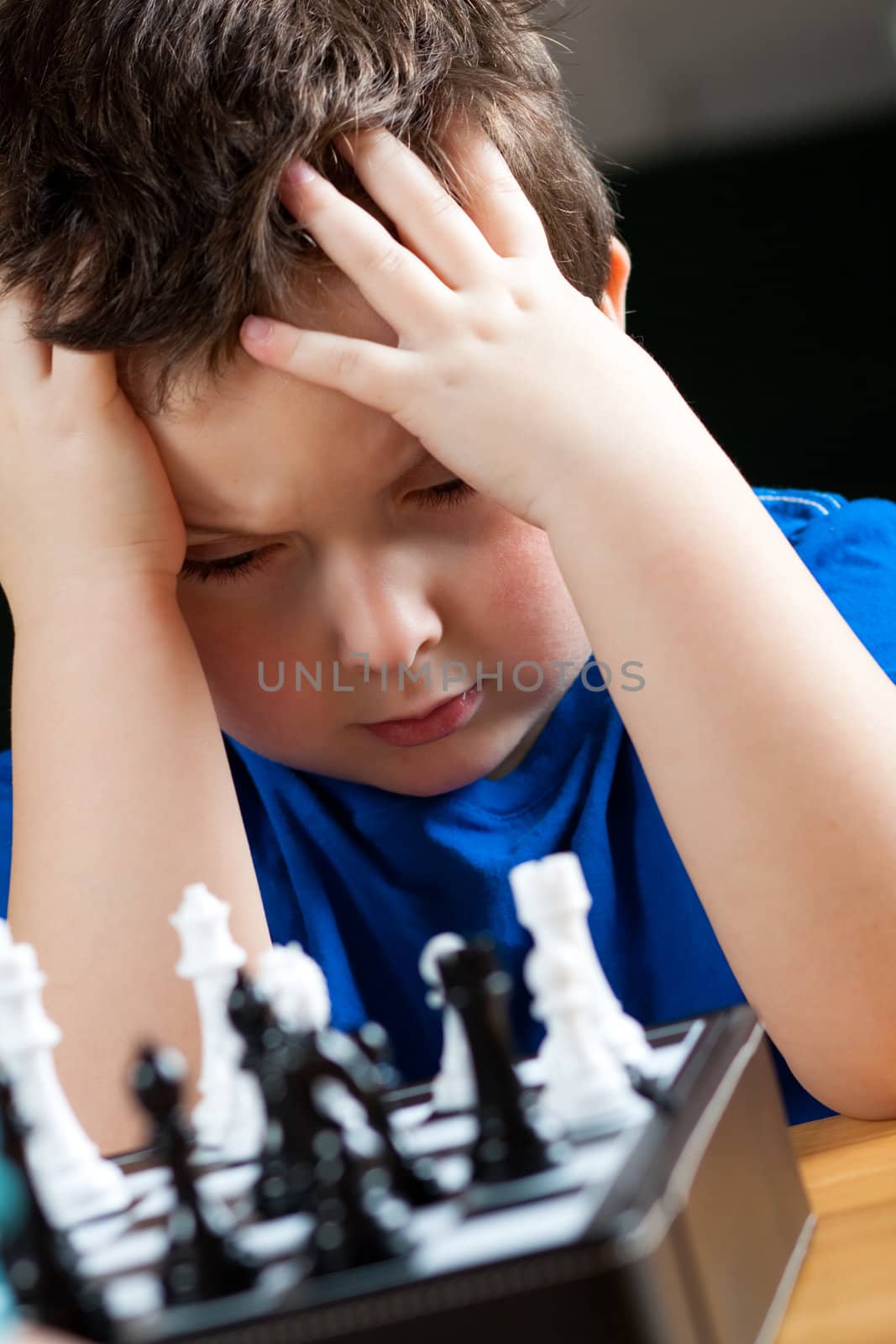 Cute little boy playing chess