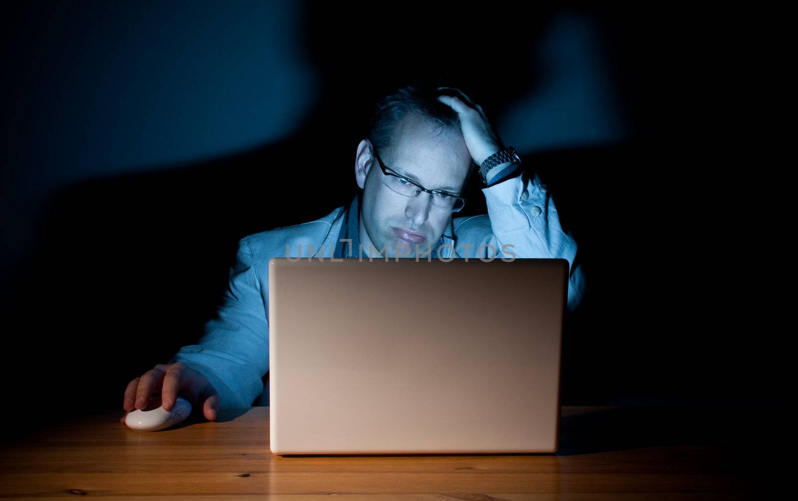Man looking demoralized in front of his computer