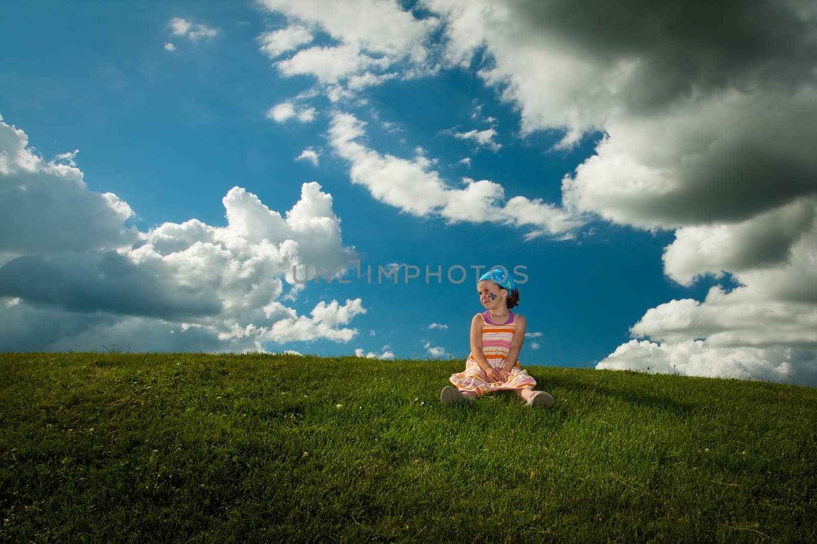 Girl sitting on the grass by Talanis