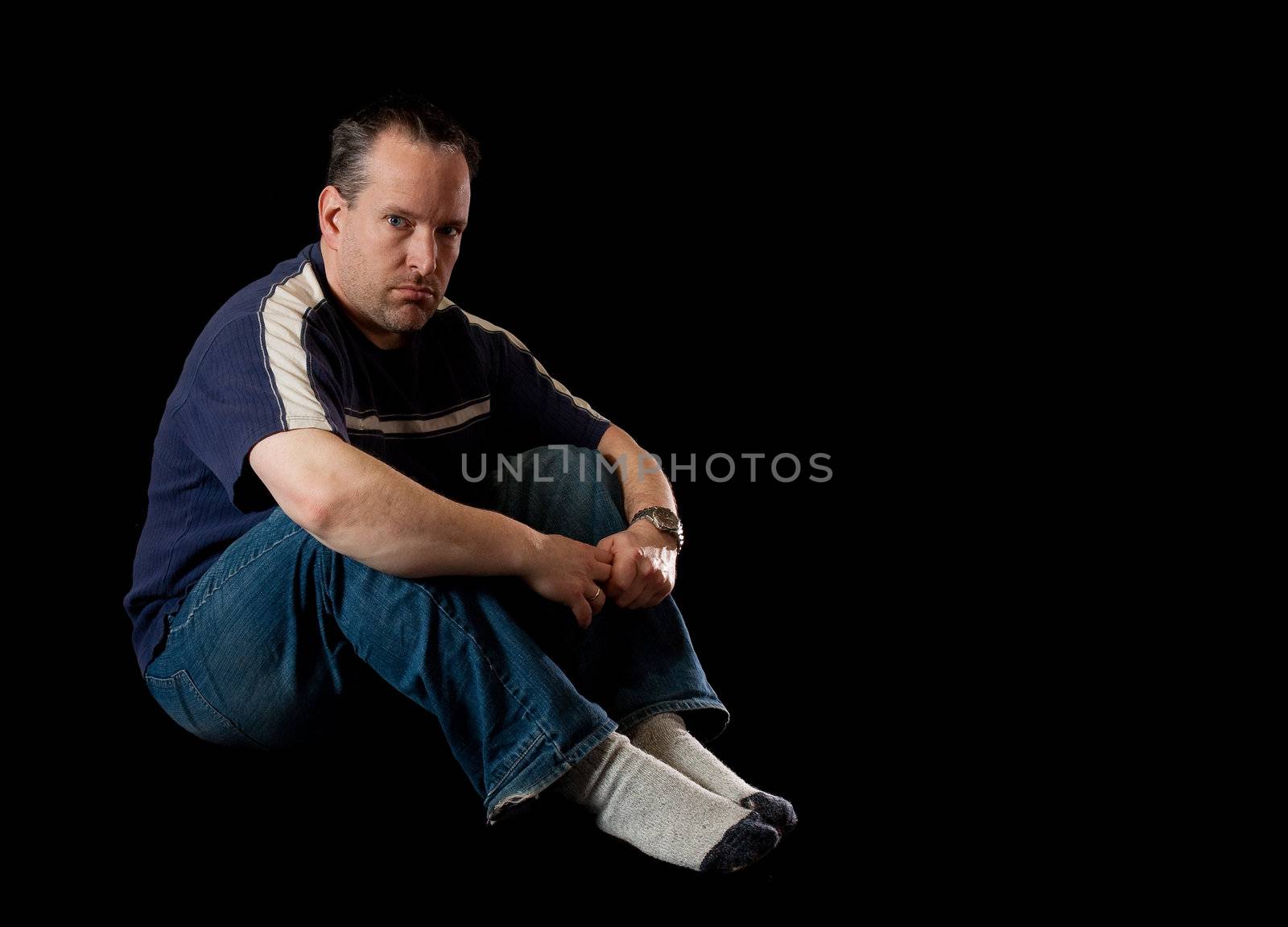 Depressed man on black background